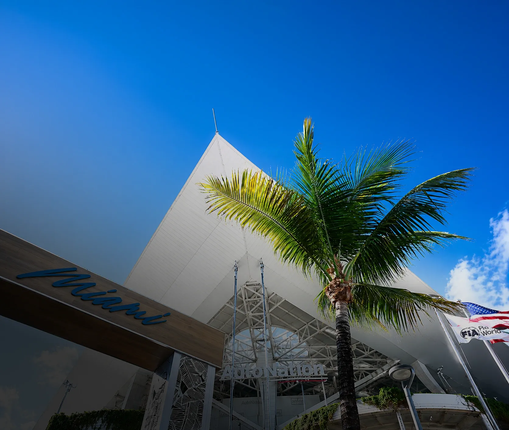 Tall palm tree perspective shot in front of the Auto Nation Building in Miami during the Grand Prix Week 2026