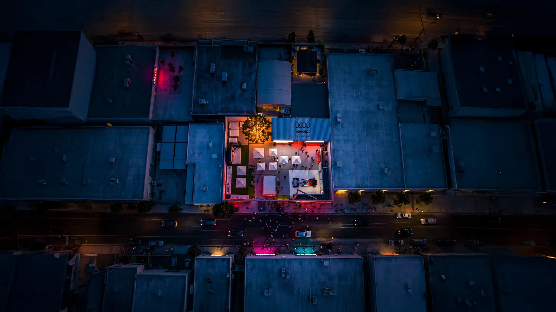 Top-down shot of branded event setup with colorful lighting in urban Miami setting