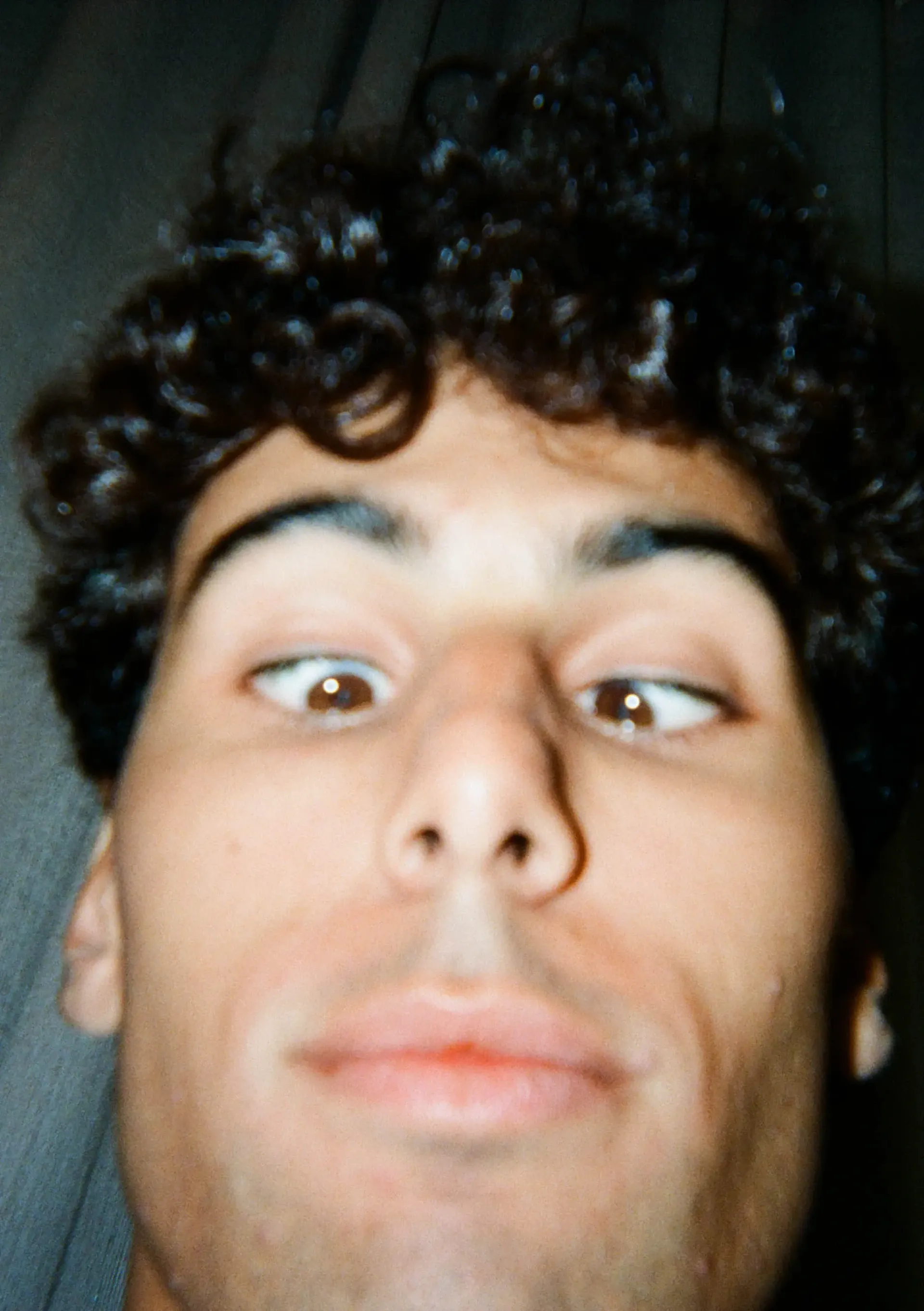 A close-up disposable-camera portrait of Gabriel Bortoleto.