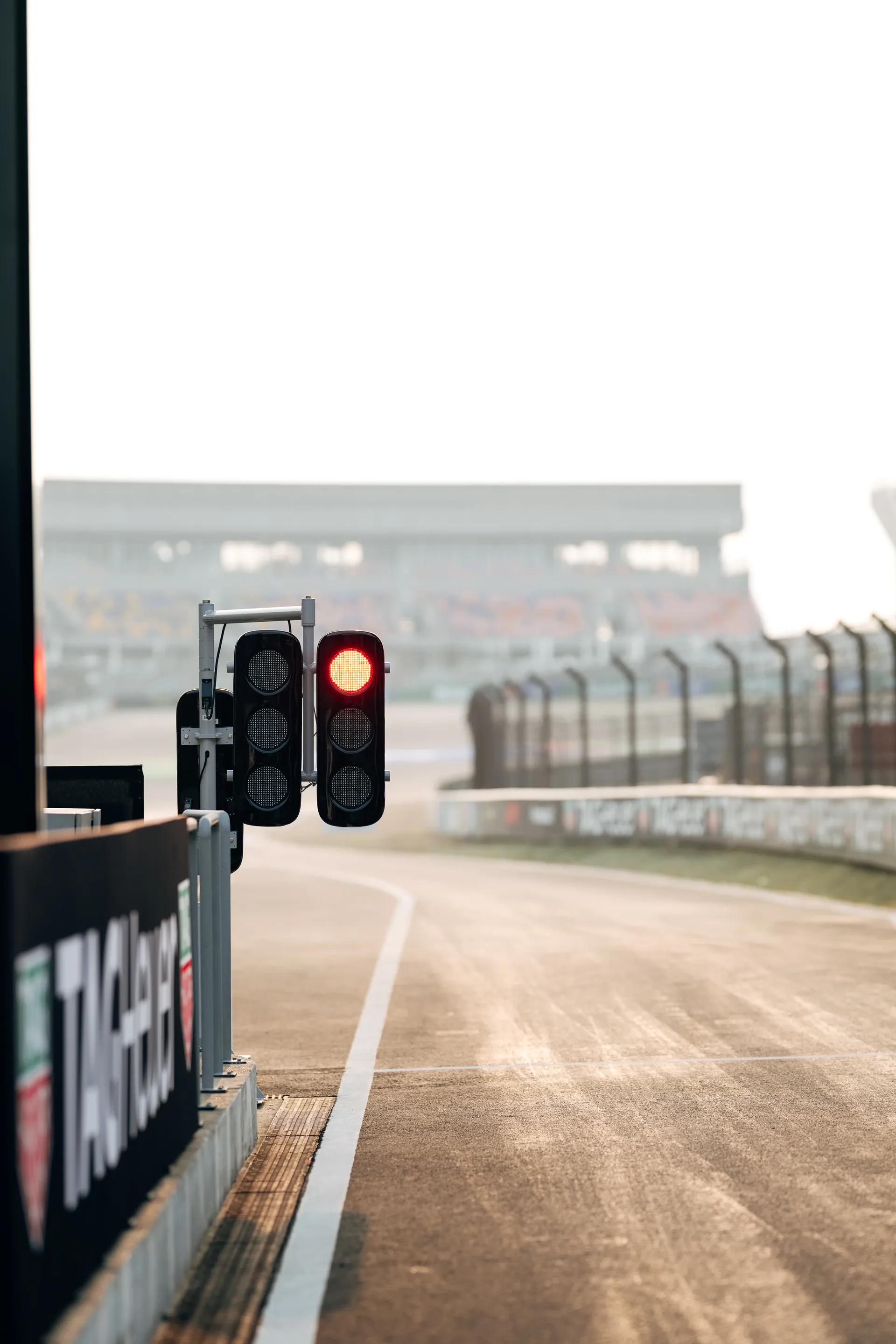 Starting lights on an empty race track under overcast conditions
