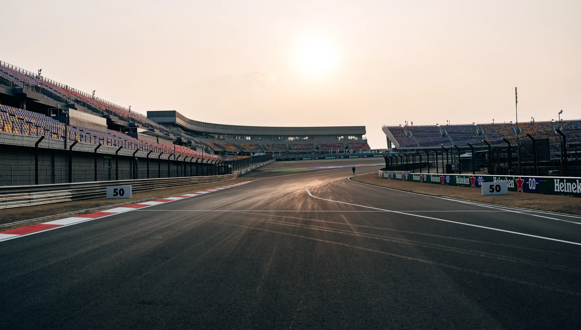 Empty start-finish straight of a race track at sunset