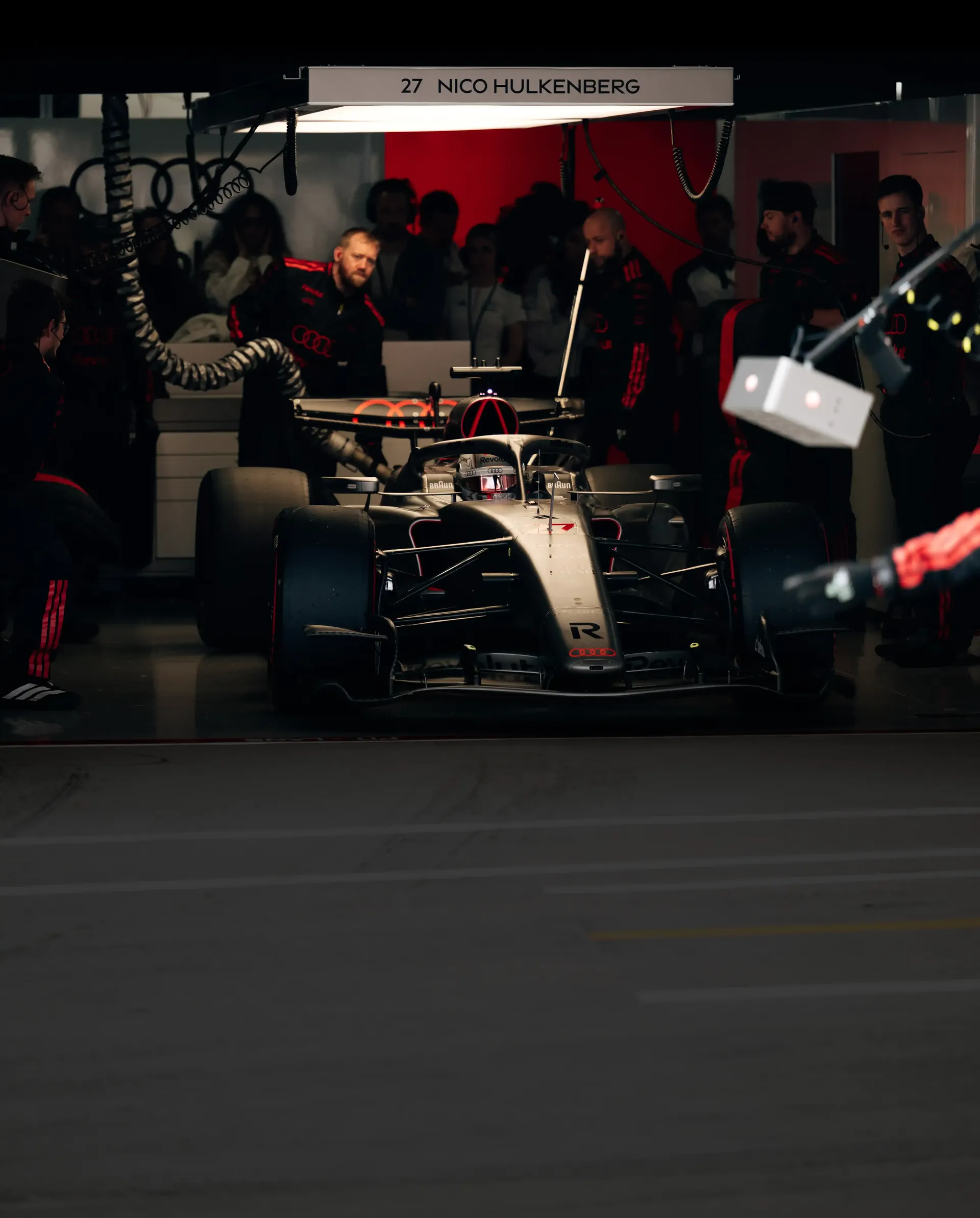 Audi Revolut F1® Team car R26 surrounded by mechanics in the garage getting ready at the Barcelona Grand Prix 2026