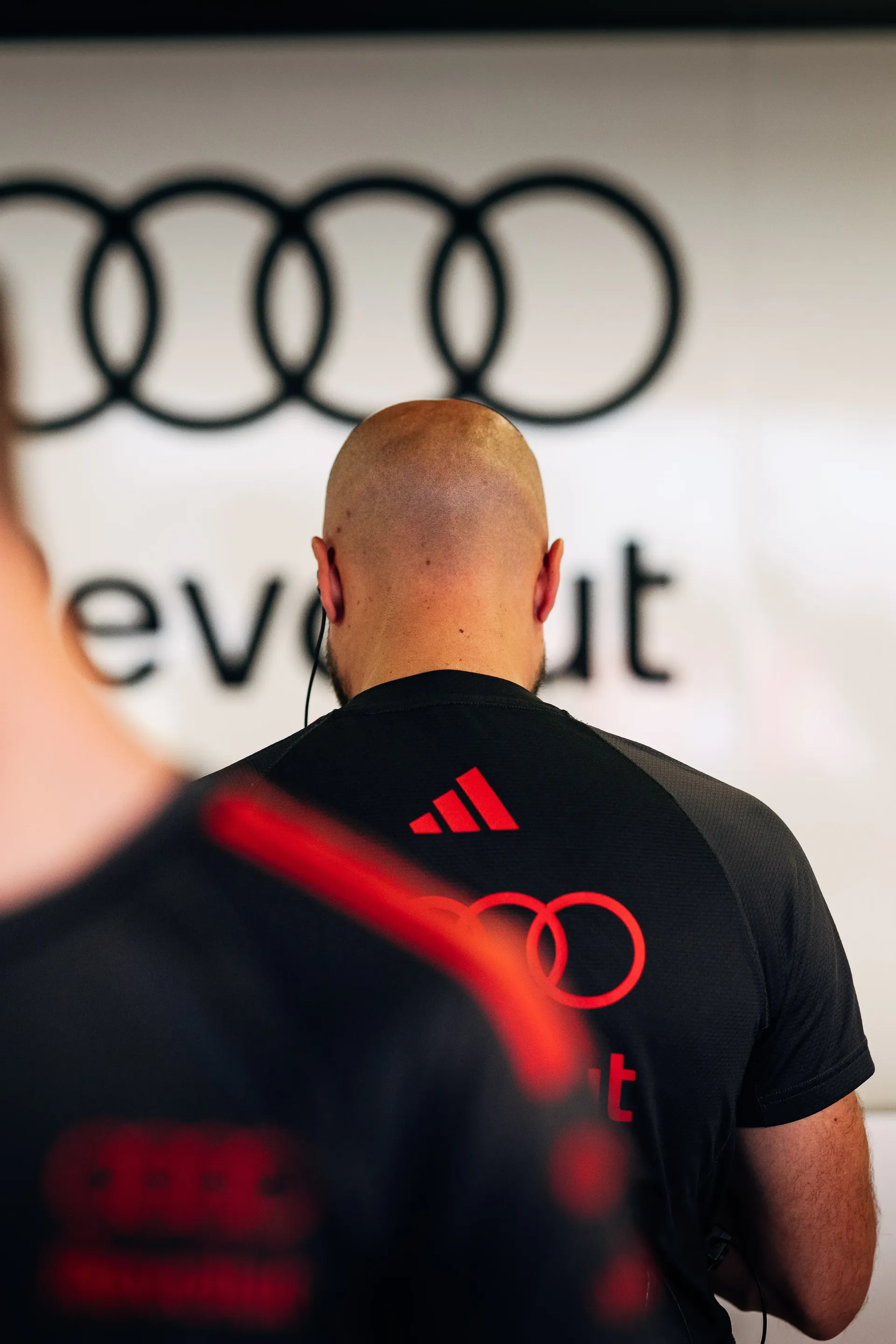 Back shot of Audi Revolut F1® Team mechanic in the garage