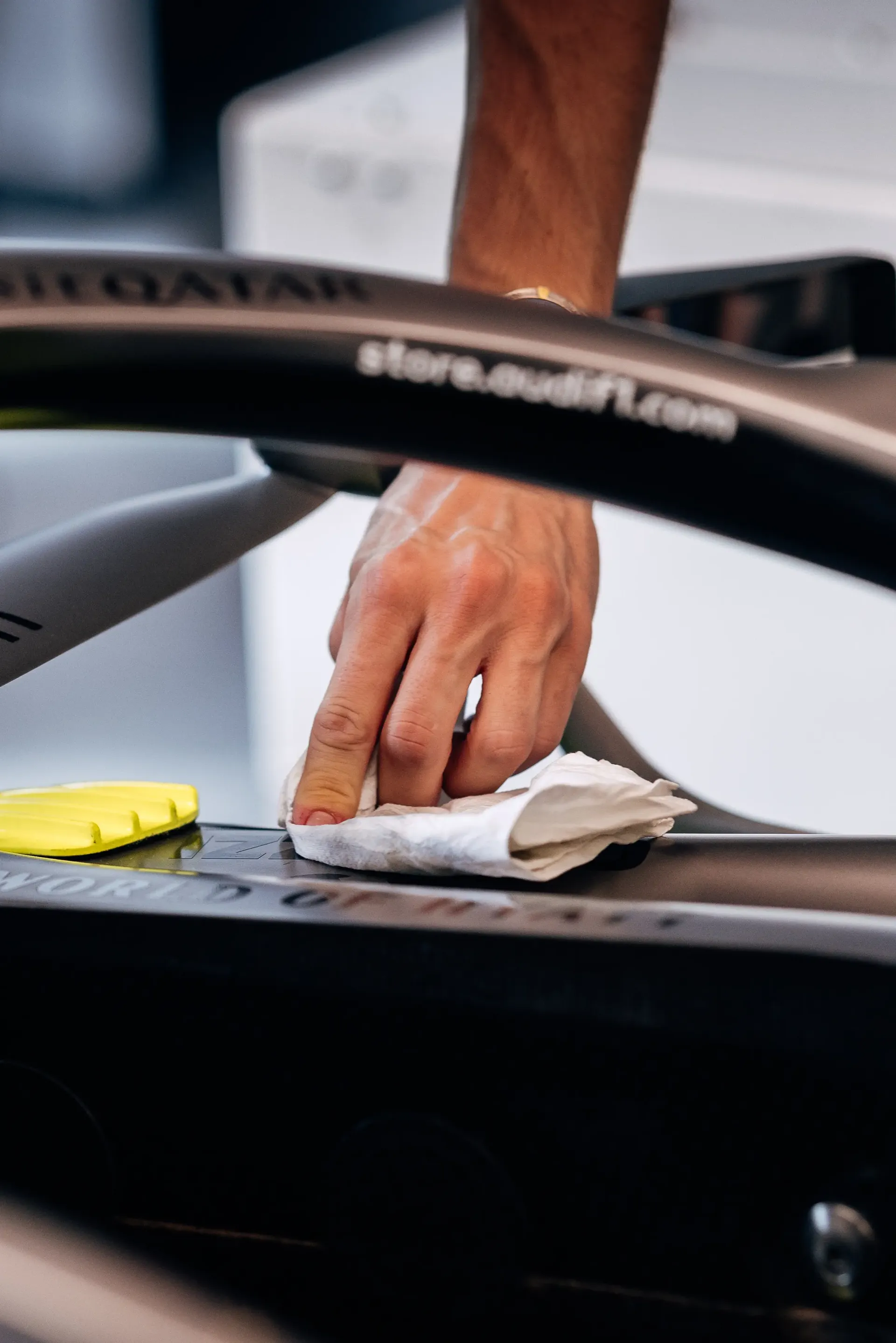 Detail shot of Audi Revolut F1® Team mechanic cleaning the Audi R26