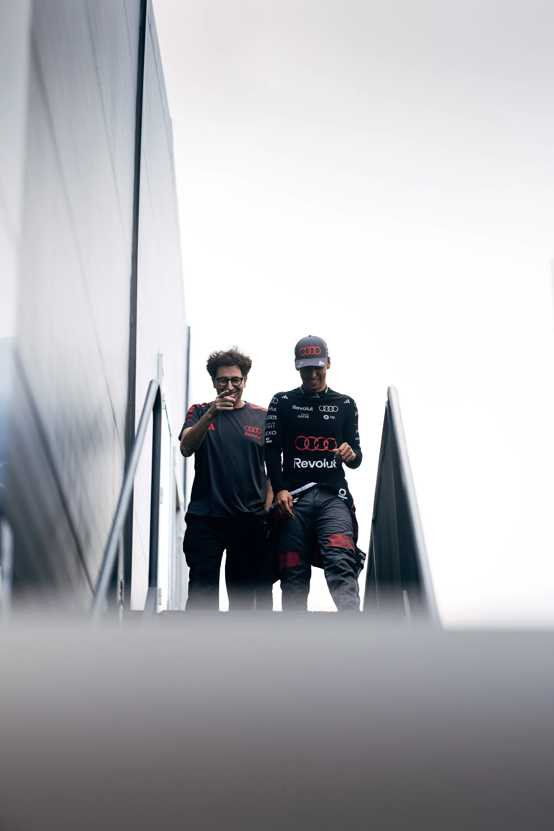 Audi Revolut F1® Team driver Gabriel Bortoleto walking through the paddock with a team member
