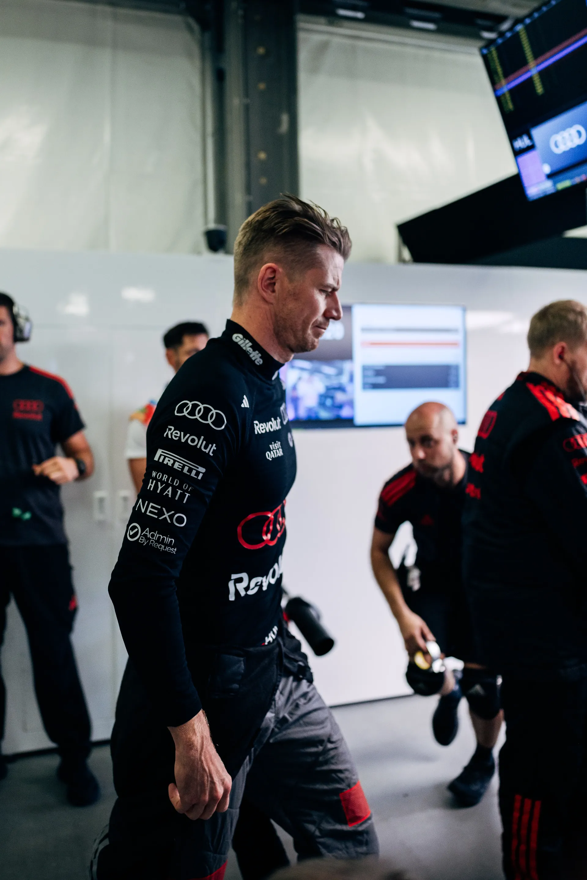 Audi Revolut F1® Team driver Nico Hulkenberg walking through the garage