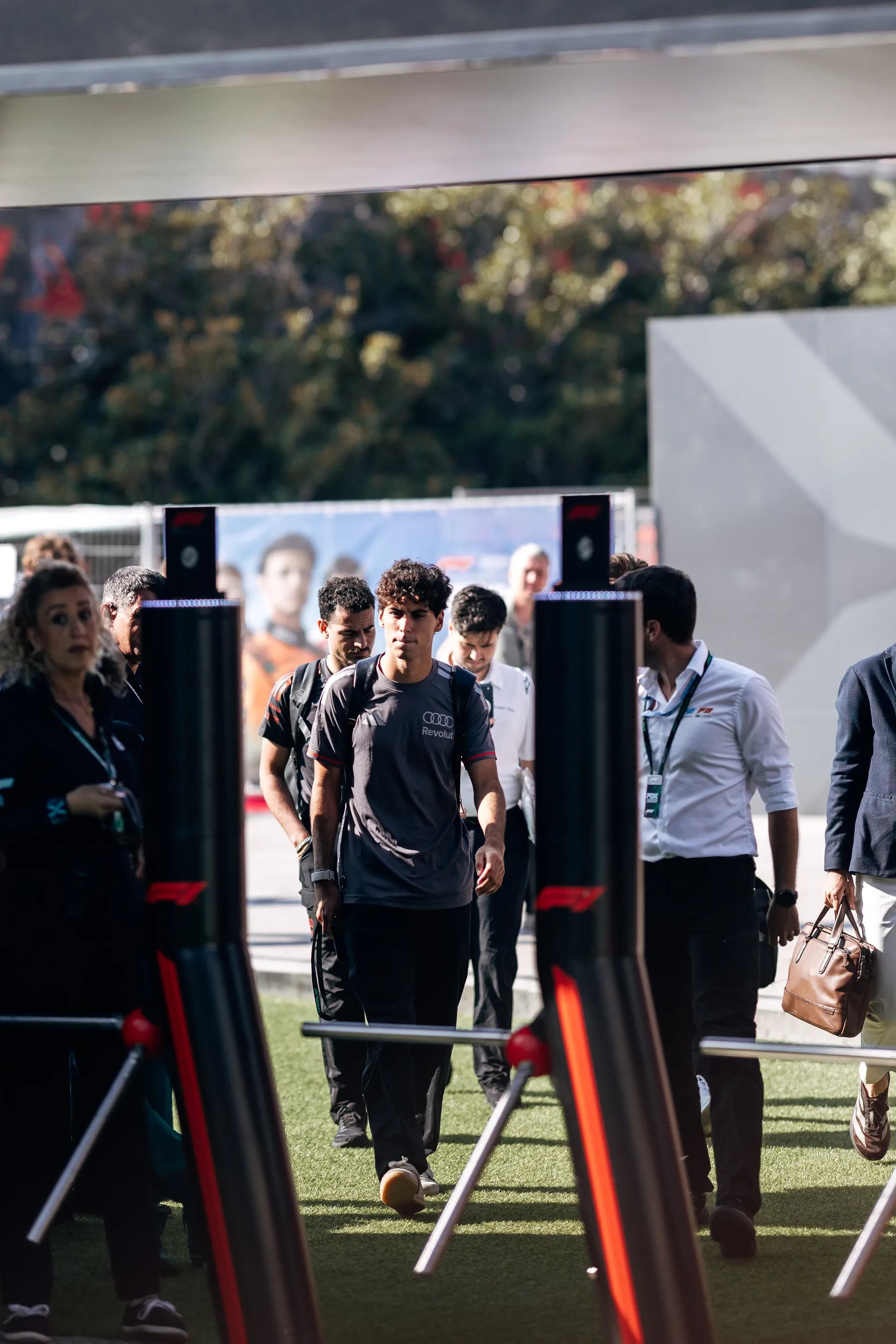 Audi Revolut F1® Team driver Gabriel Bortoleto arrives with crew members at the Baku City Circuit