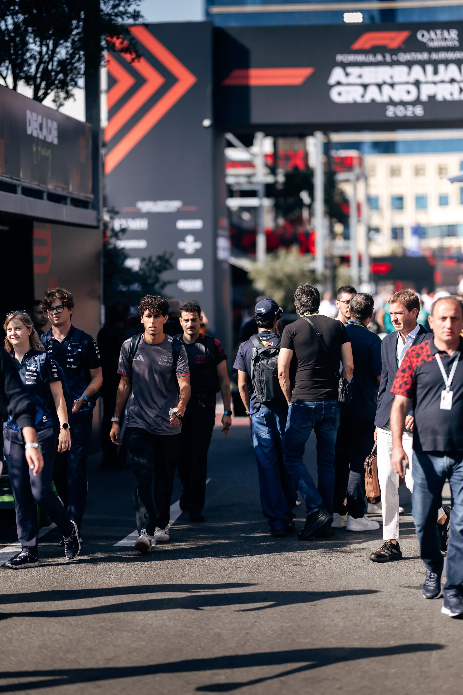 Audi Revolut F1® Team driver Gabriel Bortoleto arrives with crew members at the Baku City Circuit