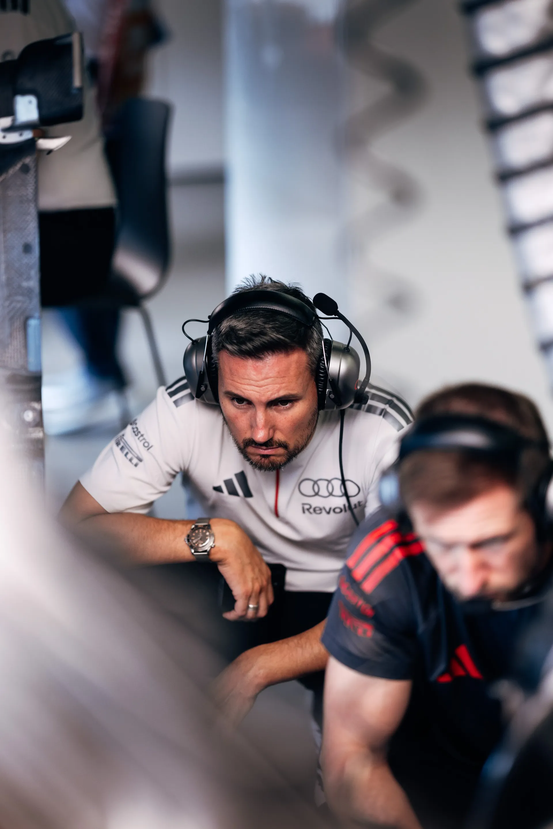 Gabriel Bortoleto, driver of the Audi Revolut F1® Team, with an engineer in the team garage.