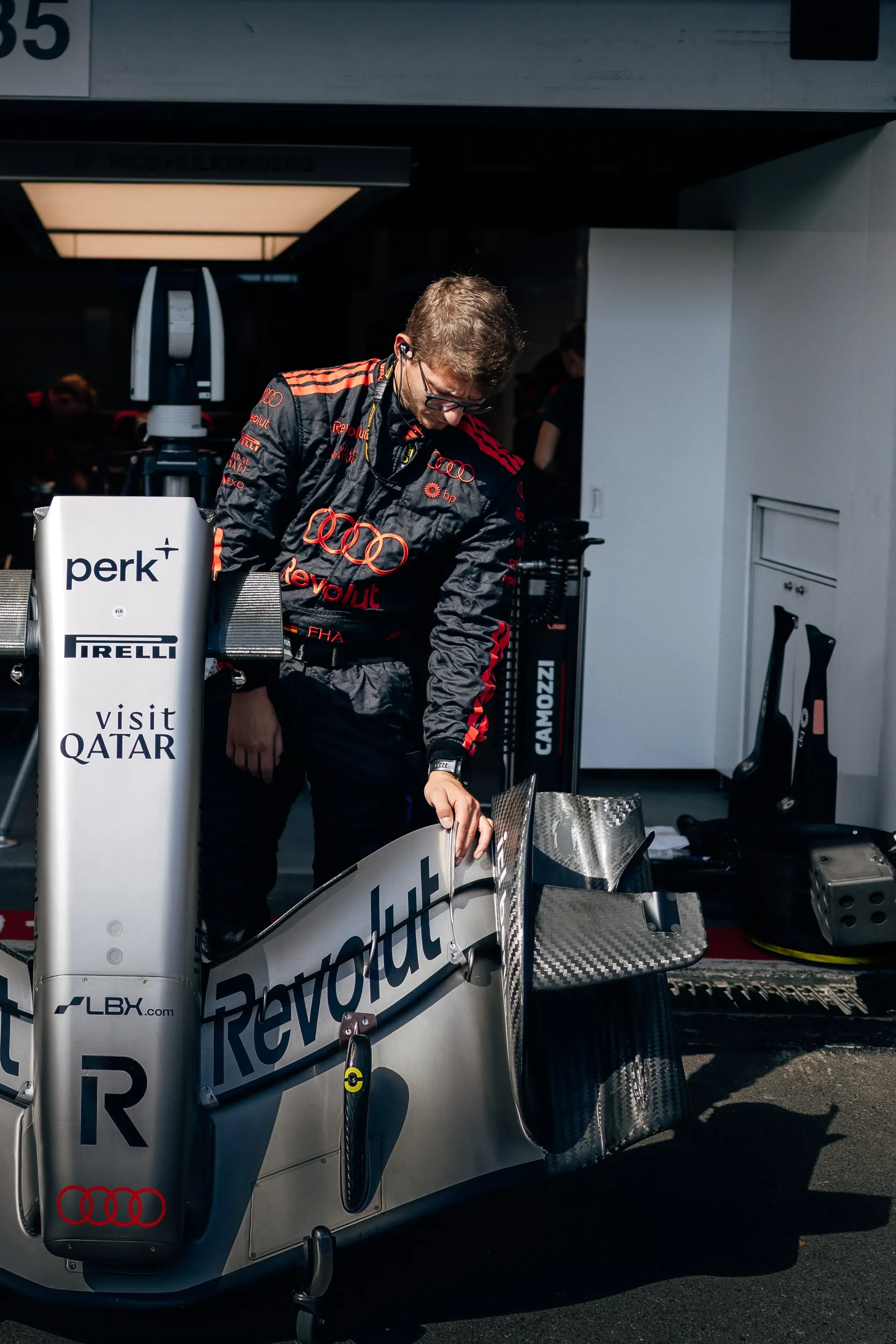 Audi Revolut F1® Team mechanic working on the car in the garage.