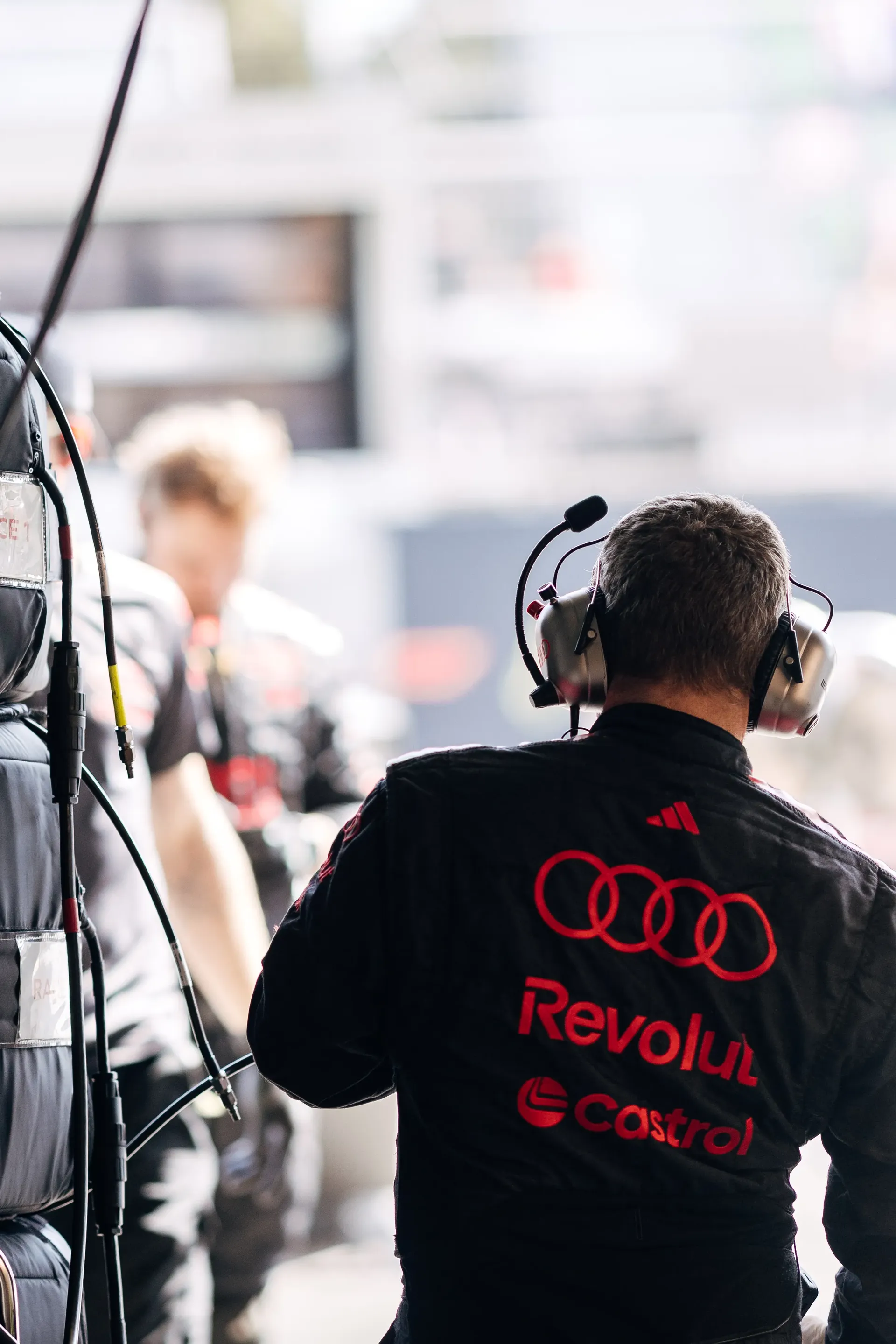 Audi Revolut F1® Team mechanic walking through the paddock.