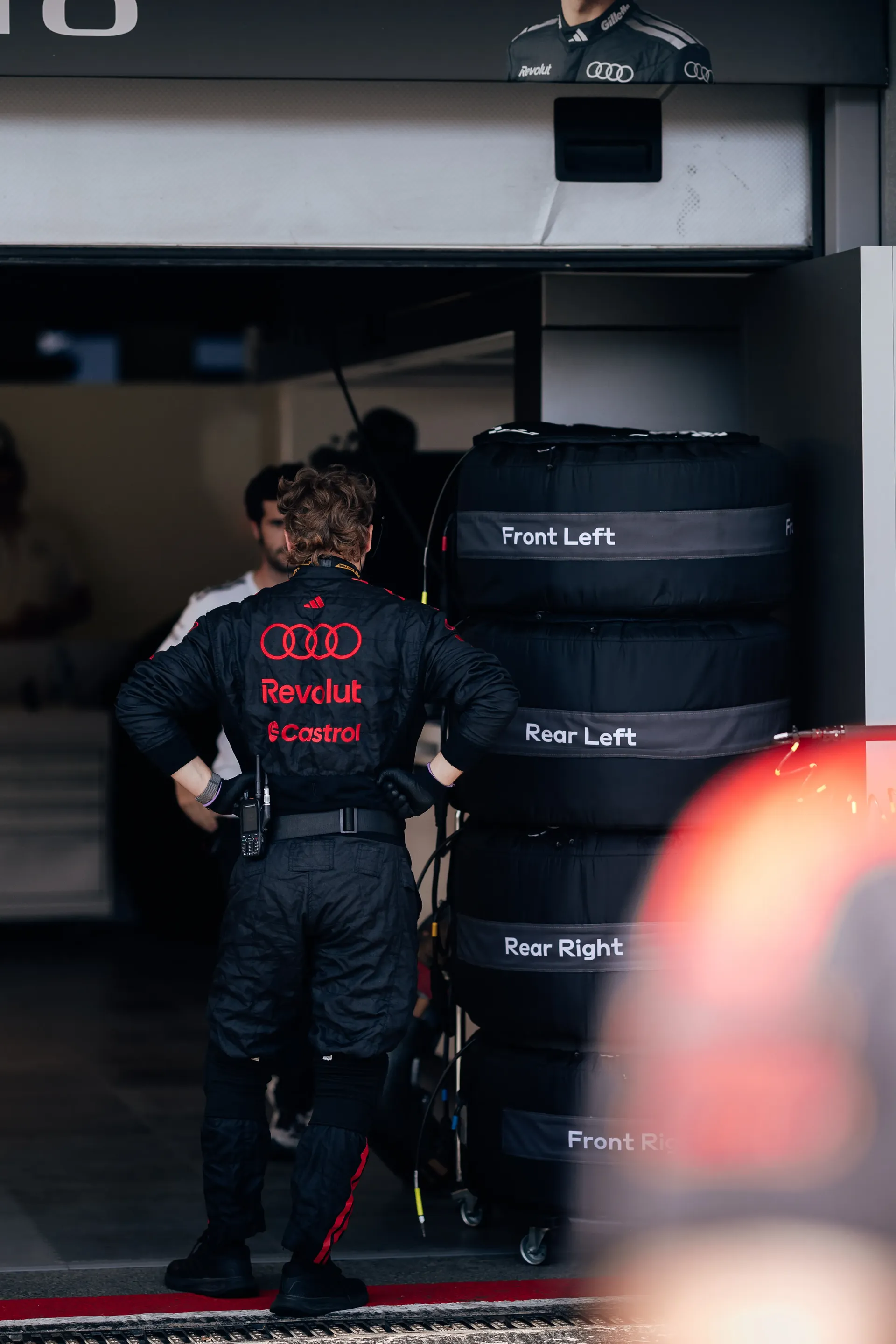 Audi Revolut F1® Team mechanic walking through the garage.