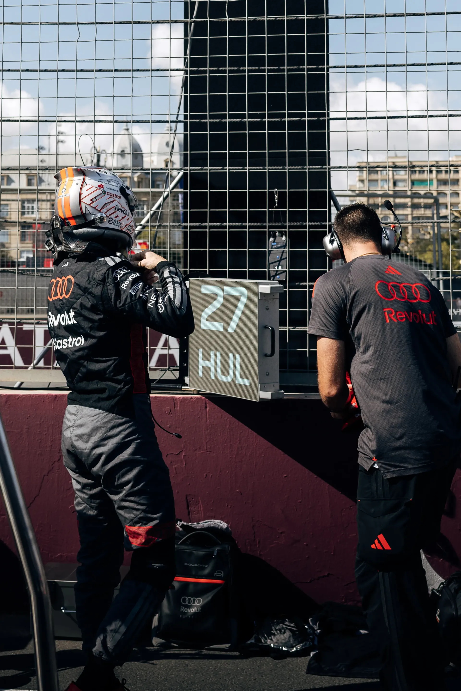 Audi Revolut F1® Team mechanics working beside the R26 team car in the paddock.