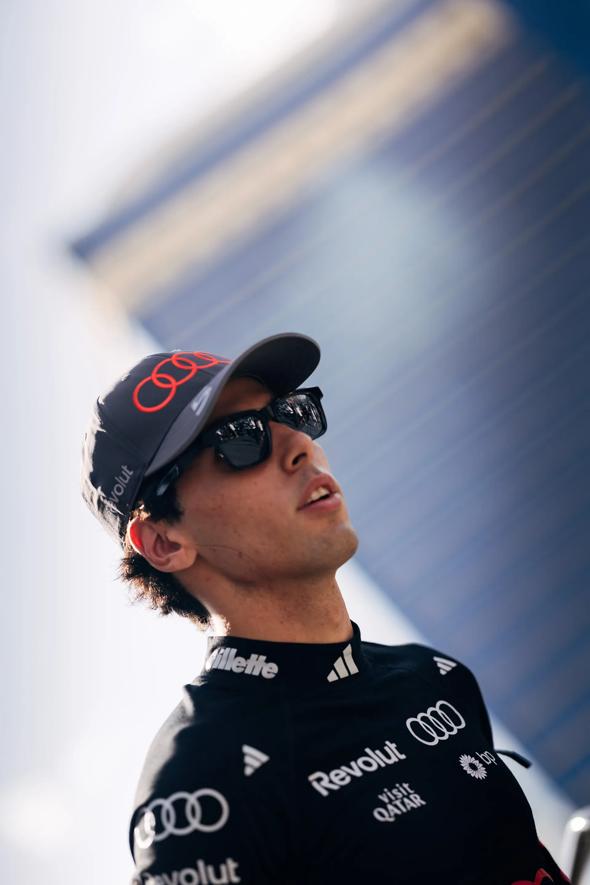 Gabriel Bortoleto, driver of the Audi Revolut F1® Team, looking up in the paddock.
