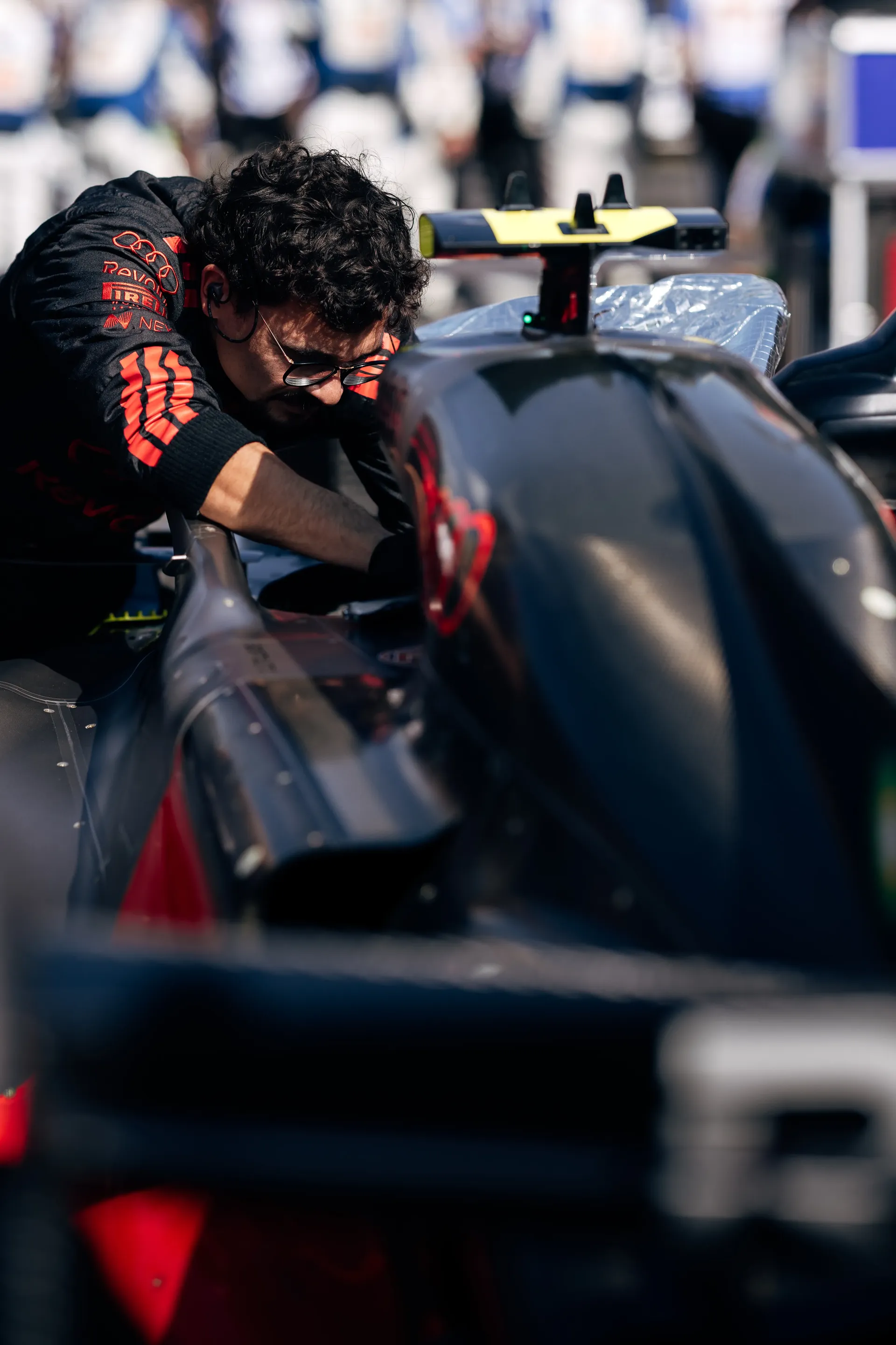 Audi Revolut F1® Team mechanic working on the car in the pit lane.