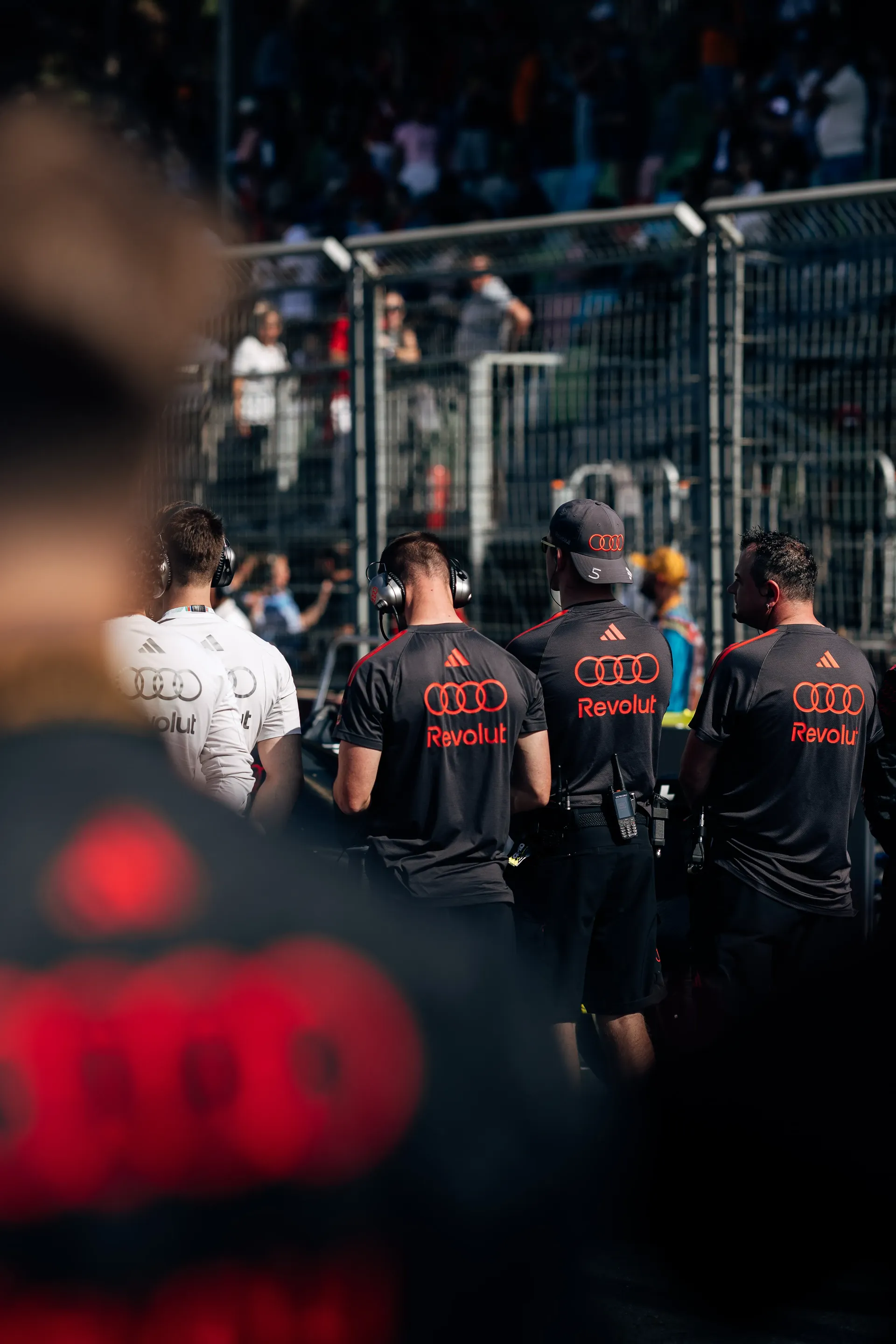 Audi Revolut F1® Team mechanics walking through the paddock.