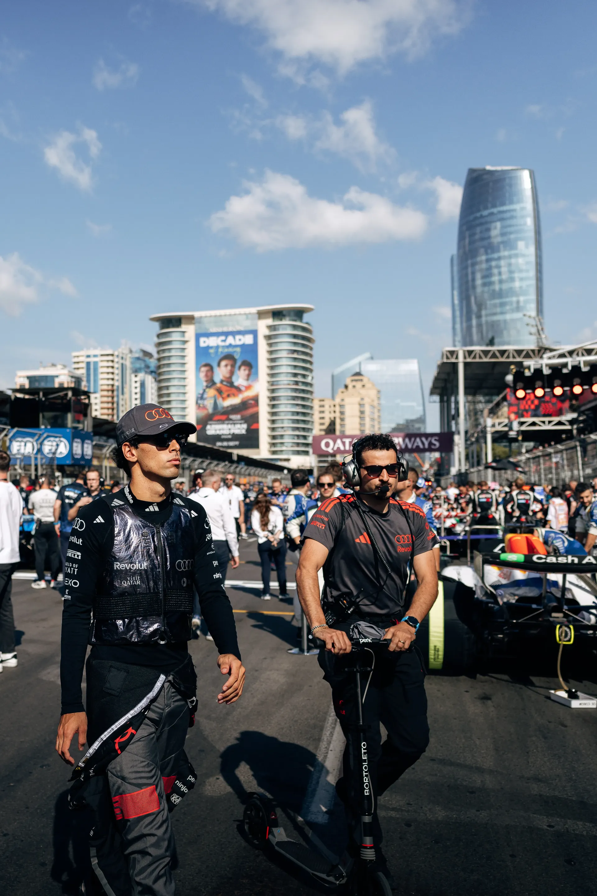 Gabriel Bortoleto and Nico Hulkenberg, drivers of the Audi Revolut F1® Team, walking through the paddock.