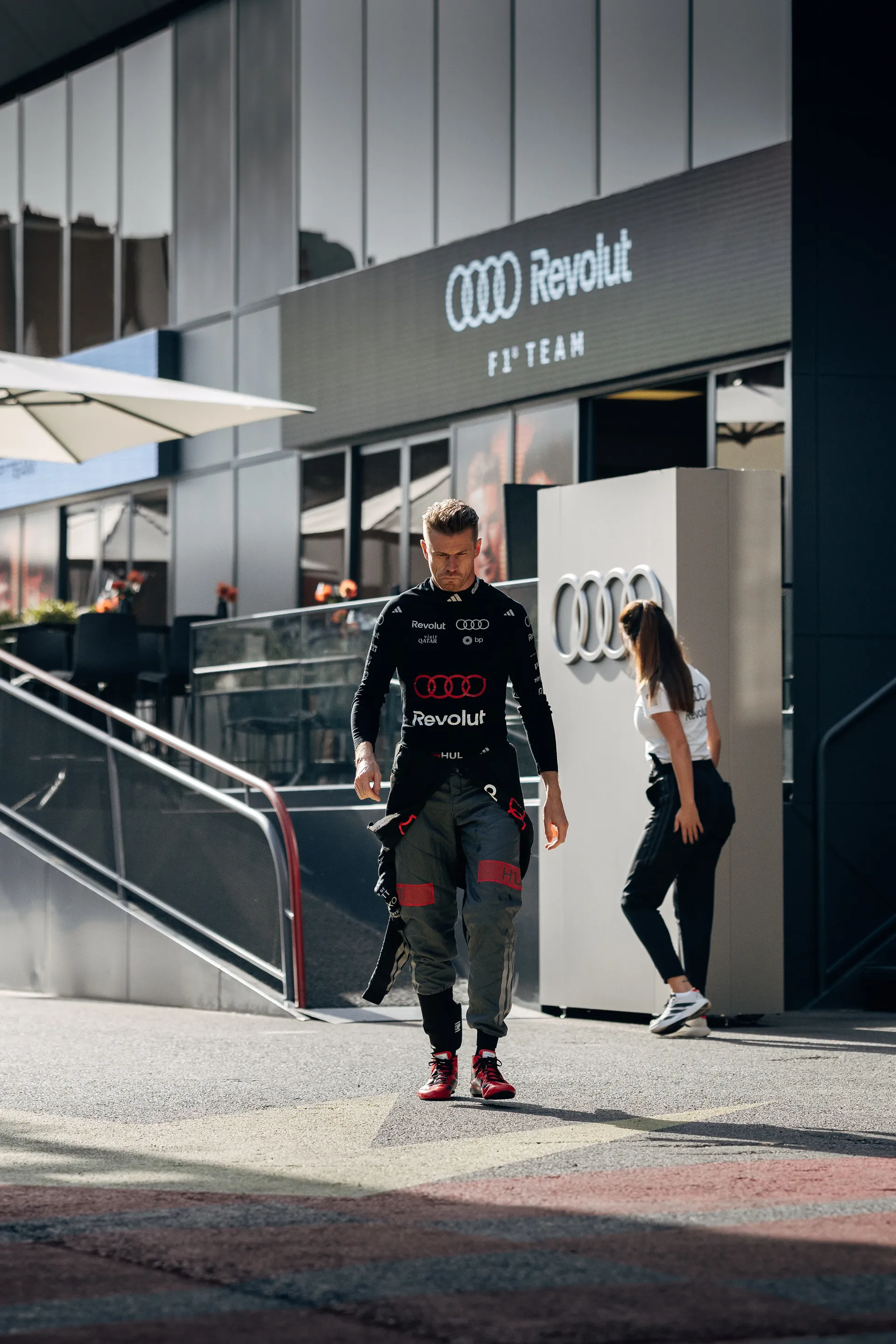 Audi Revolut F1® Team driver Nico Hulkenberg walking through the paddock