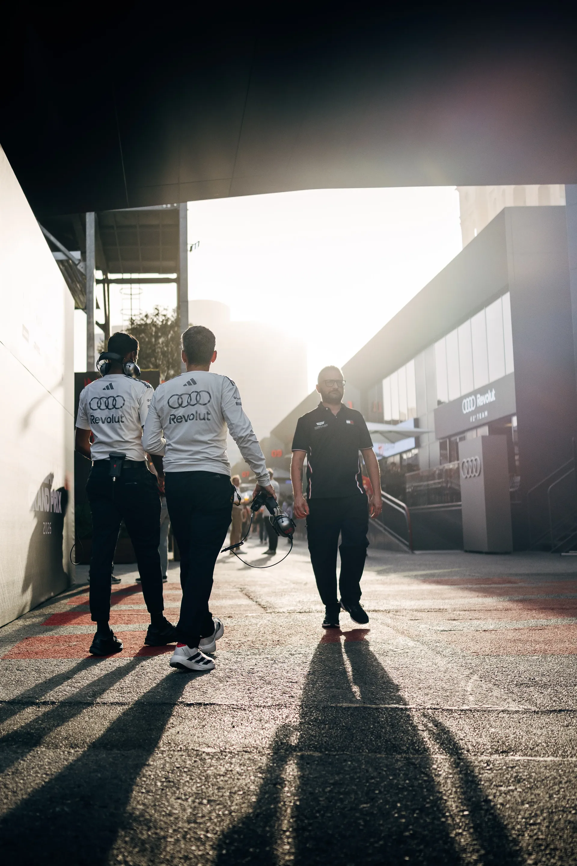 Audi Revolut F1® Team team members walking through the paddock