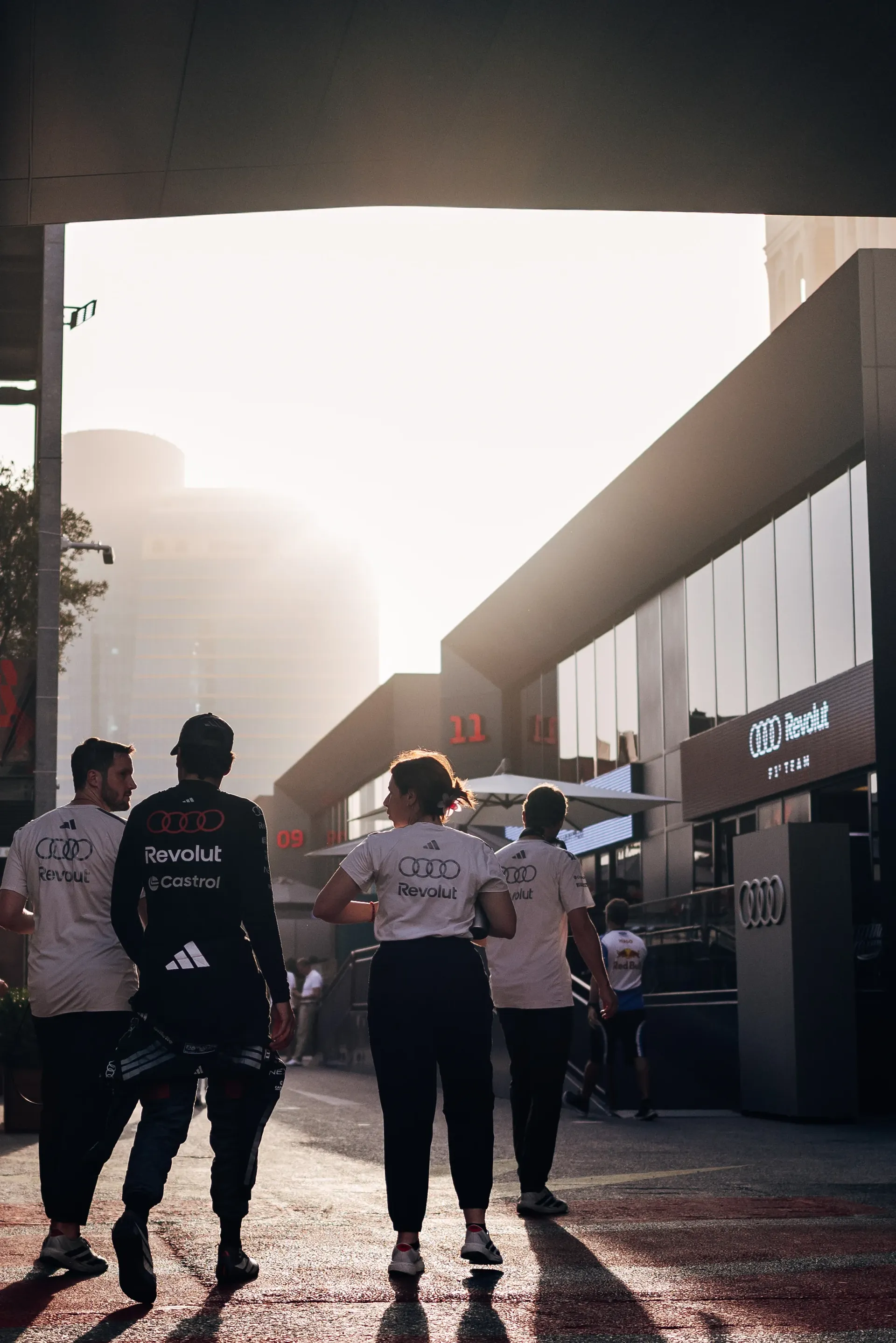 Audi Revolut F1® Team team members walking through the paddock