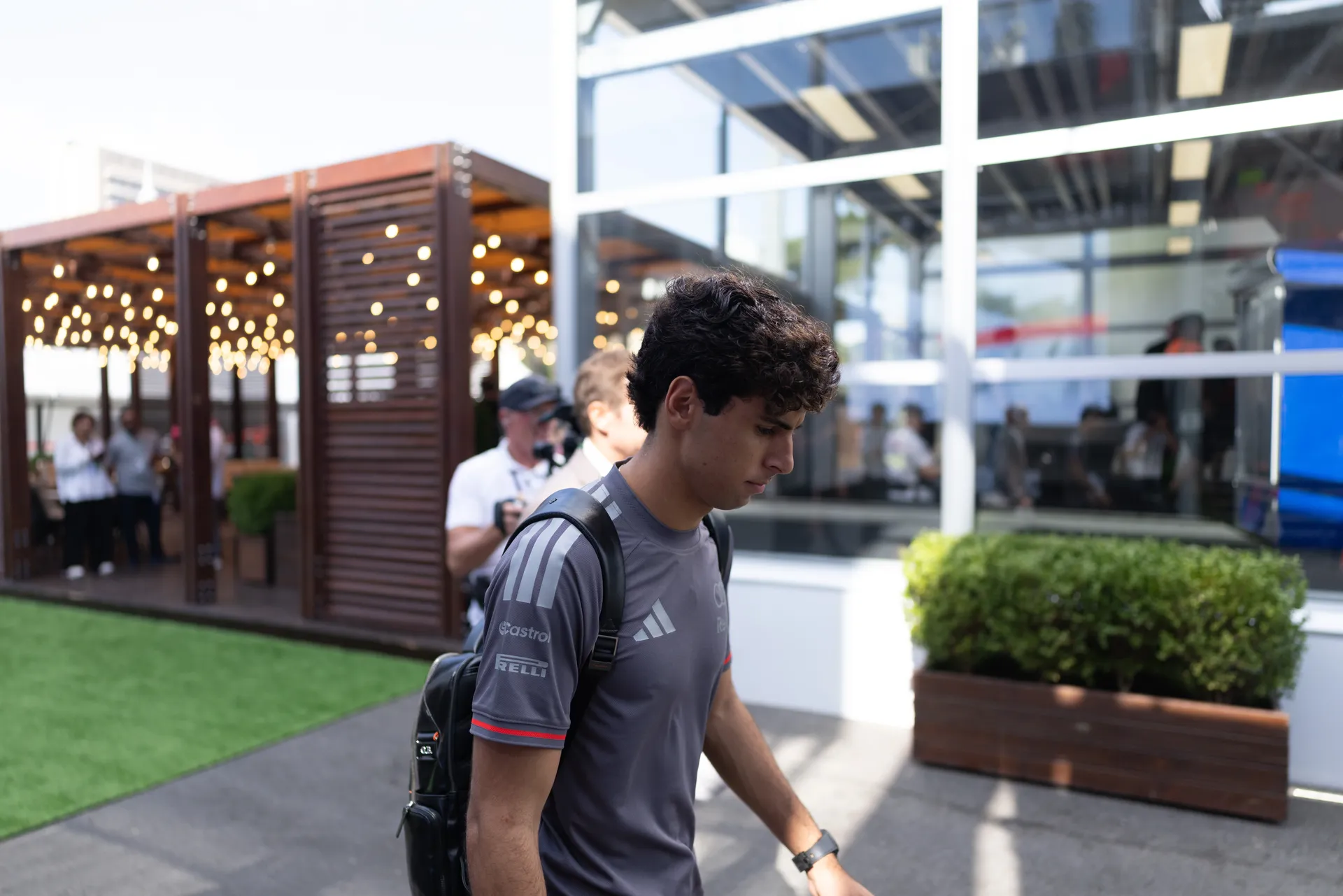 Side view of Gabriel Bortoleto, driver at Audi Revolut F1® Team, walking inside the paddock at the Azerbaijan Grand Prix