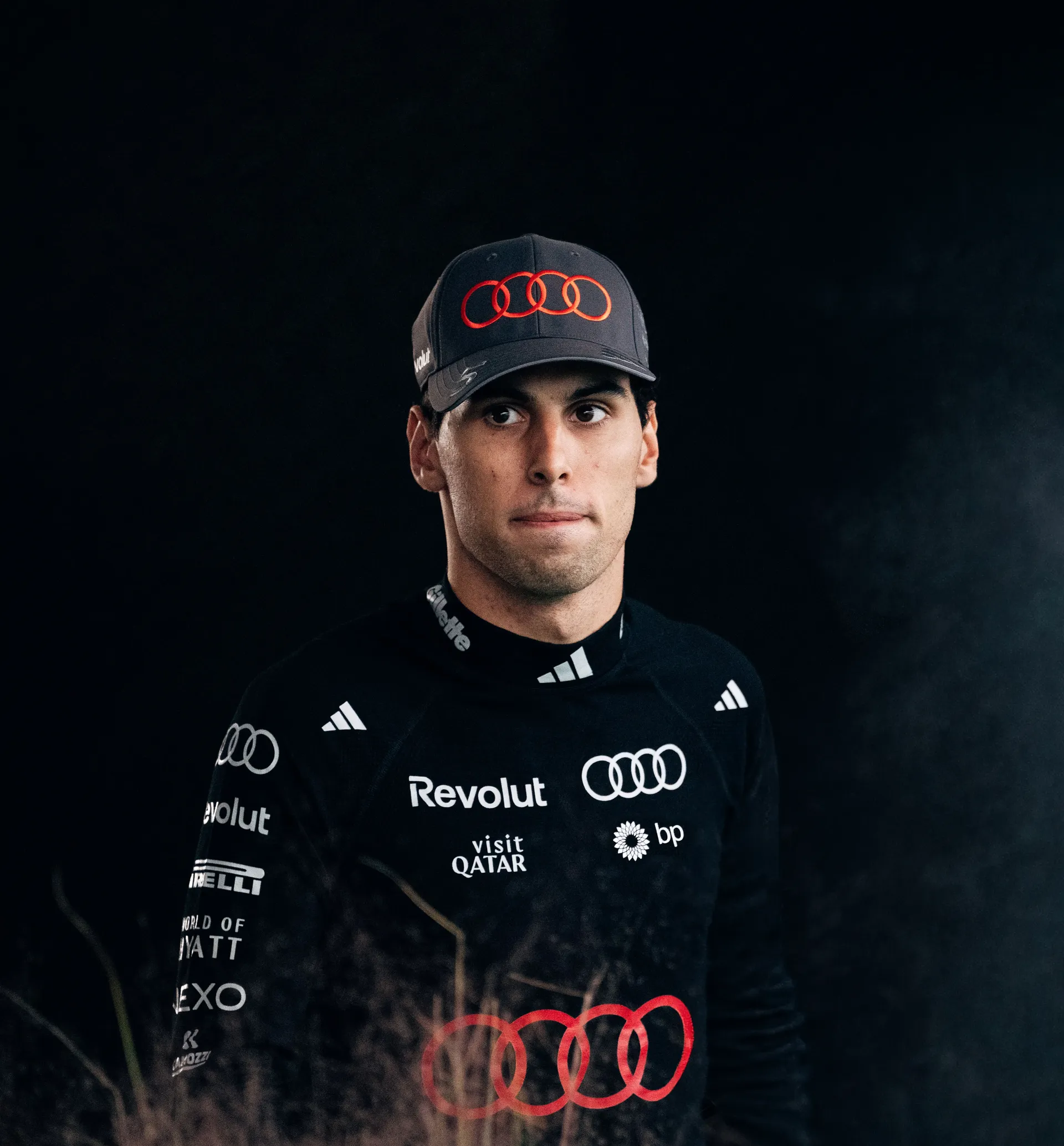 Portrait of Audi Revolut F1® Team driver Gabriel Bortoleto in a dark Audi cap and black base layer
