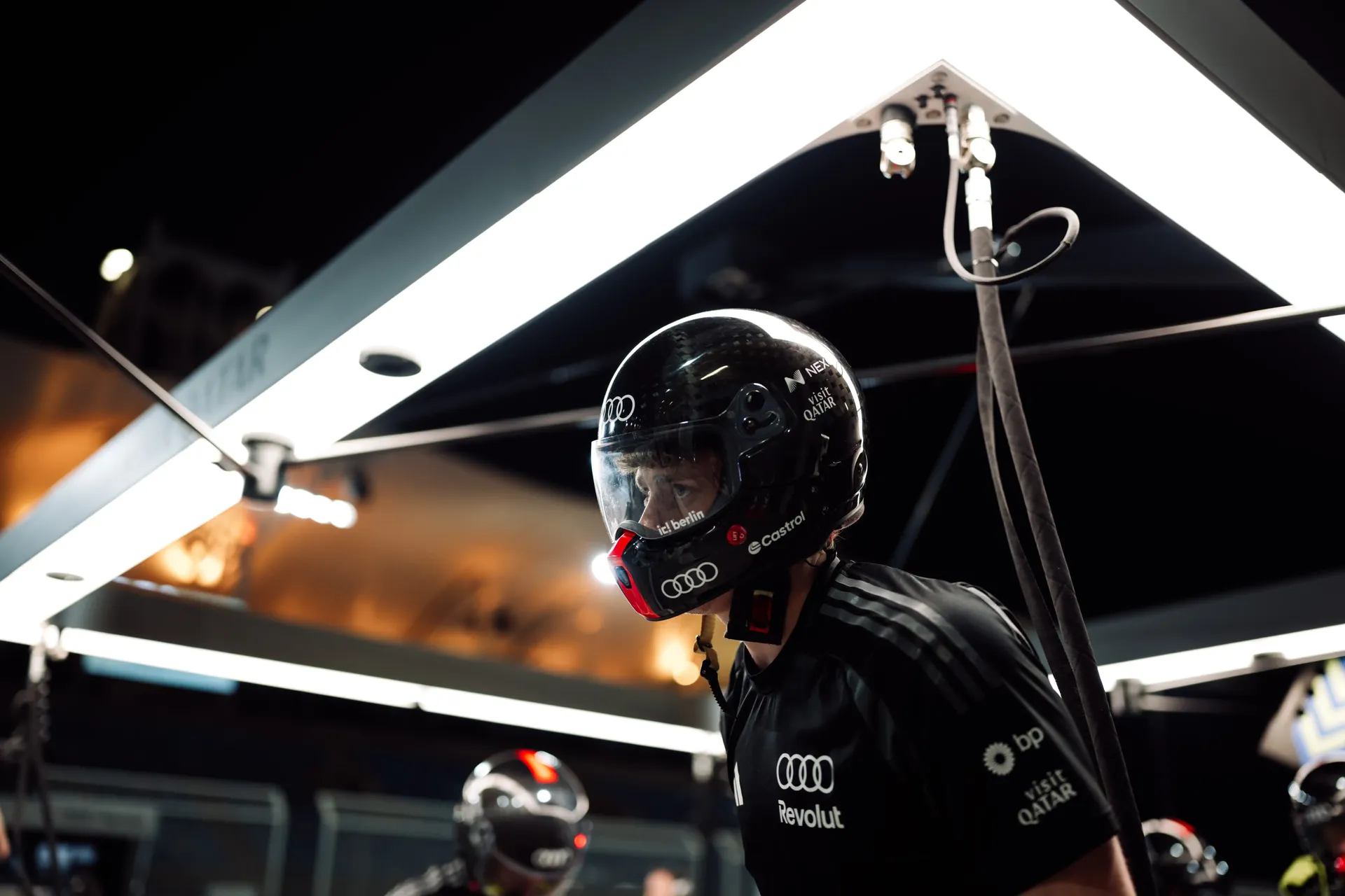 Audi Revolut F1® Team mechanic working trackside under lights at night