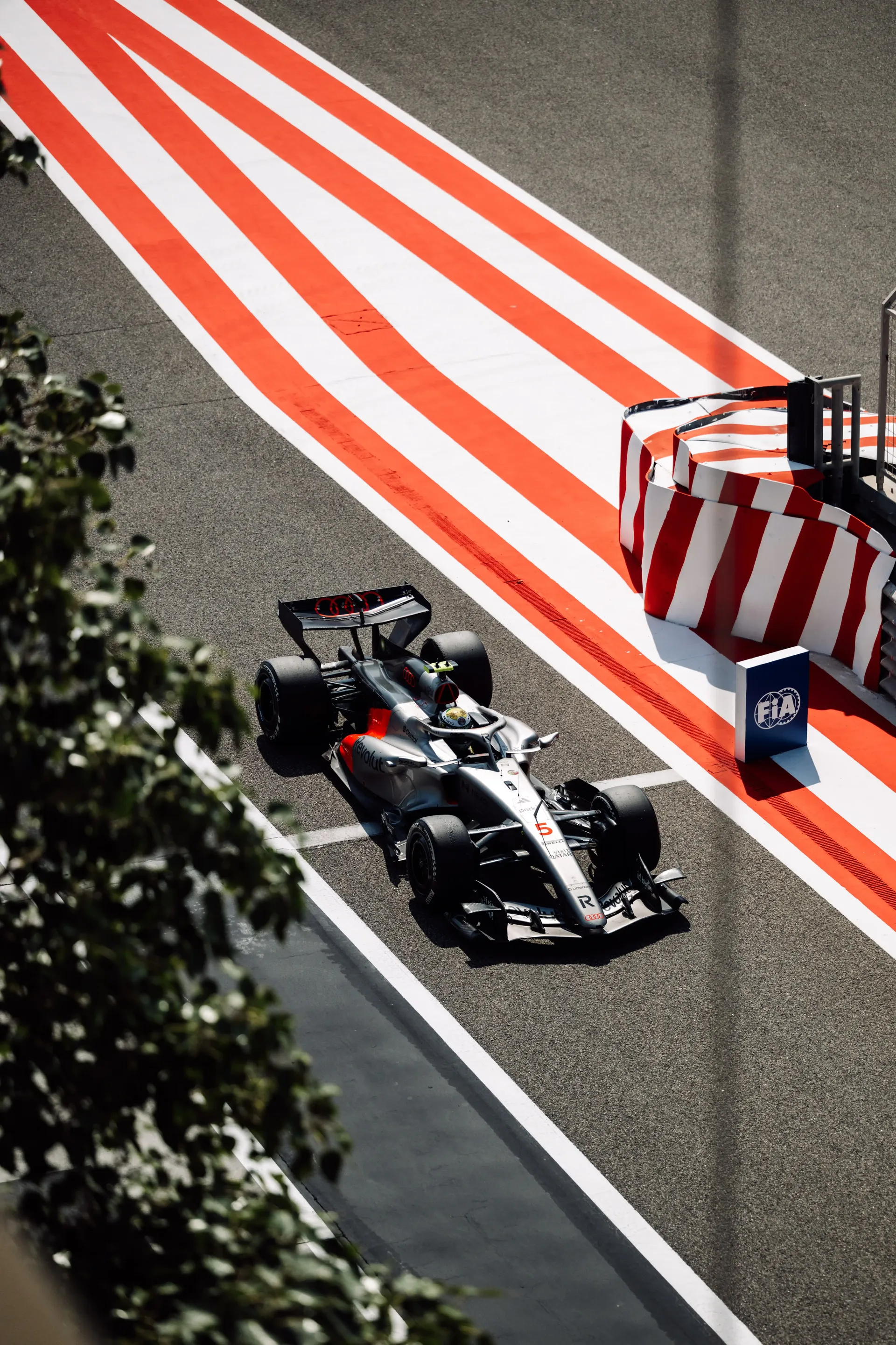Audi Revolut F1® Team car racing trough a tight section of the racetrack