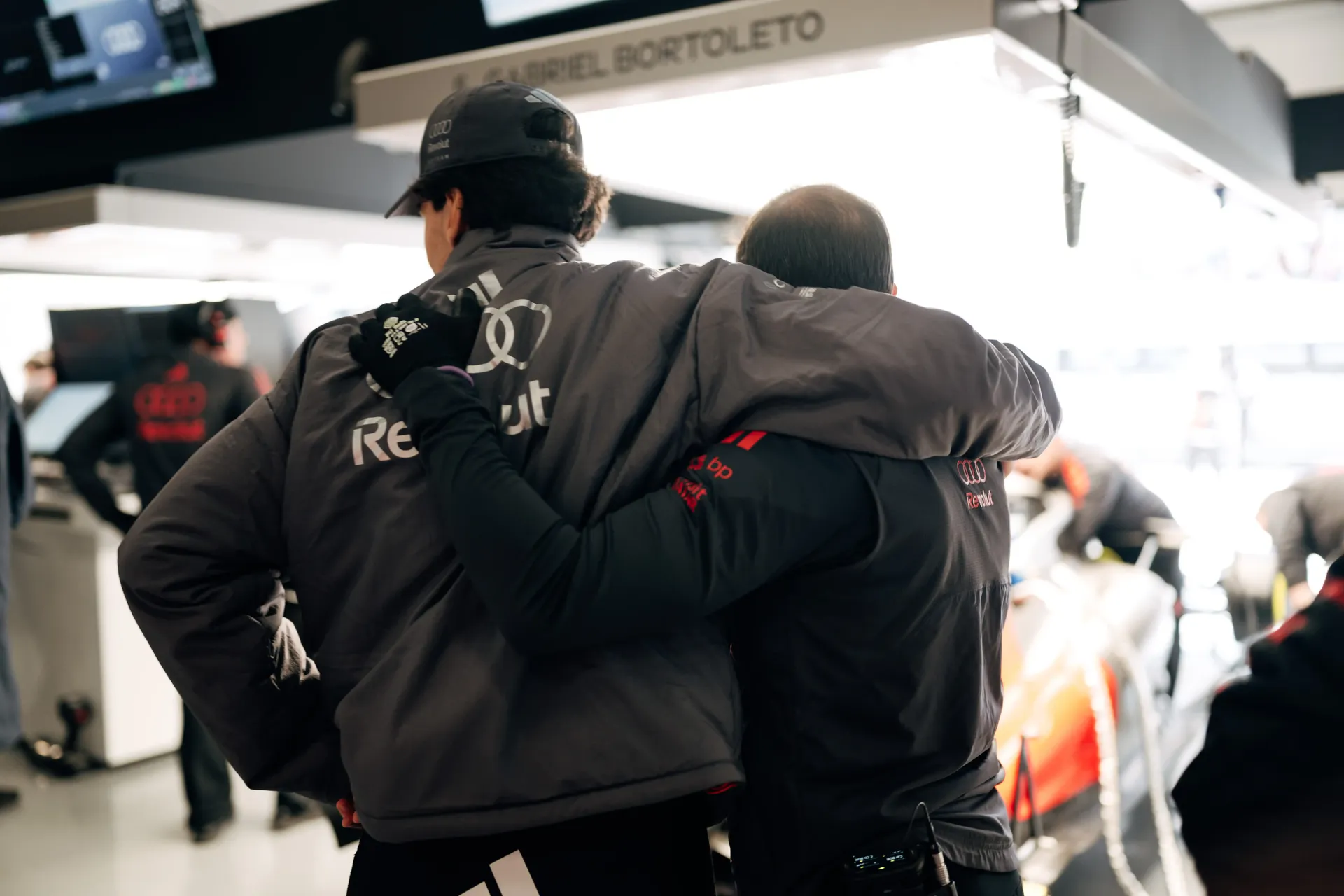 Audi Revolut F1® Team hugging inside the garage showing huge support between team members