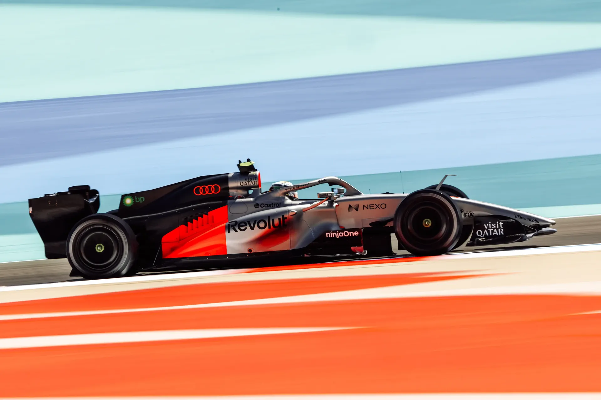 Side view of the Audi Revolut F1® Team car racing at high speed