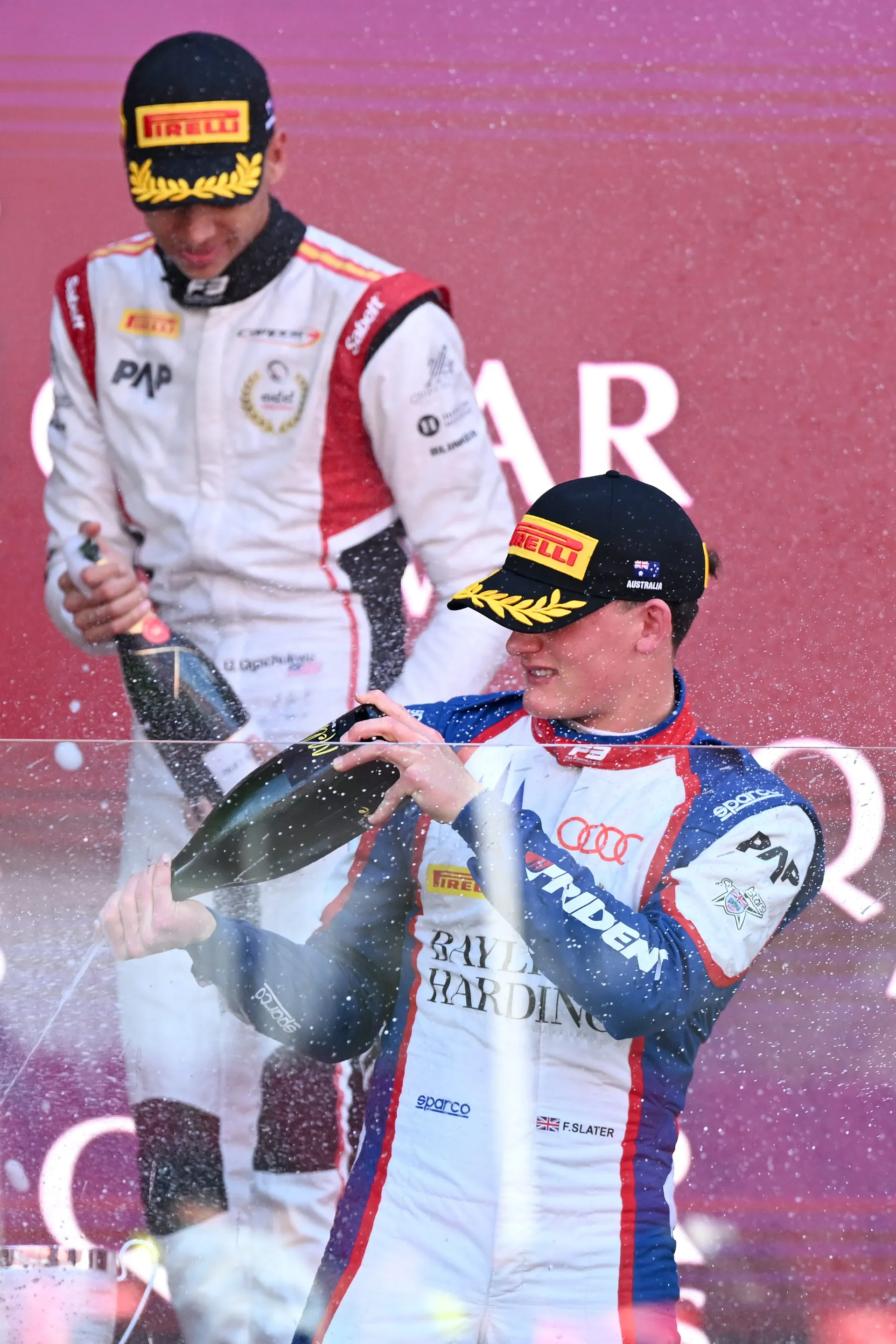 Freddie Slater and another driver spraying champagne on the podium