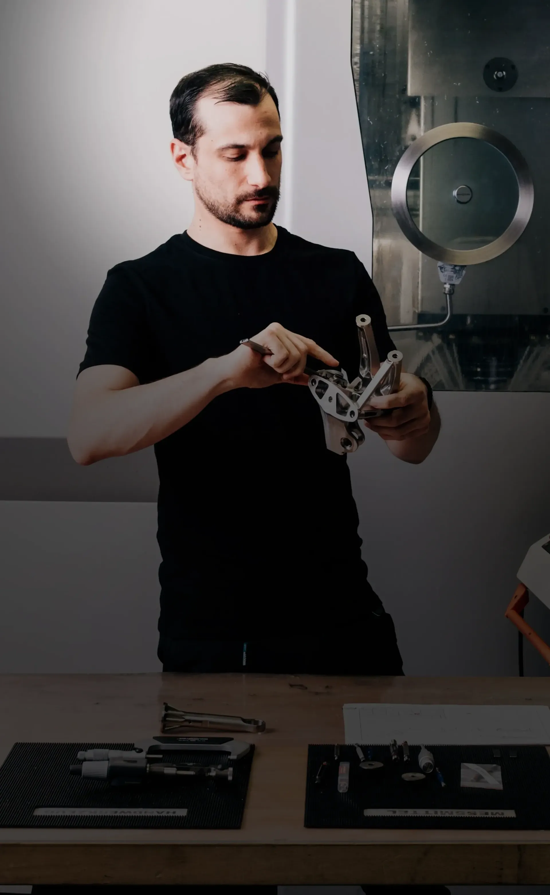 Close Up of CNC Meal Operator Giovanni working on his tool bench inside the lab