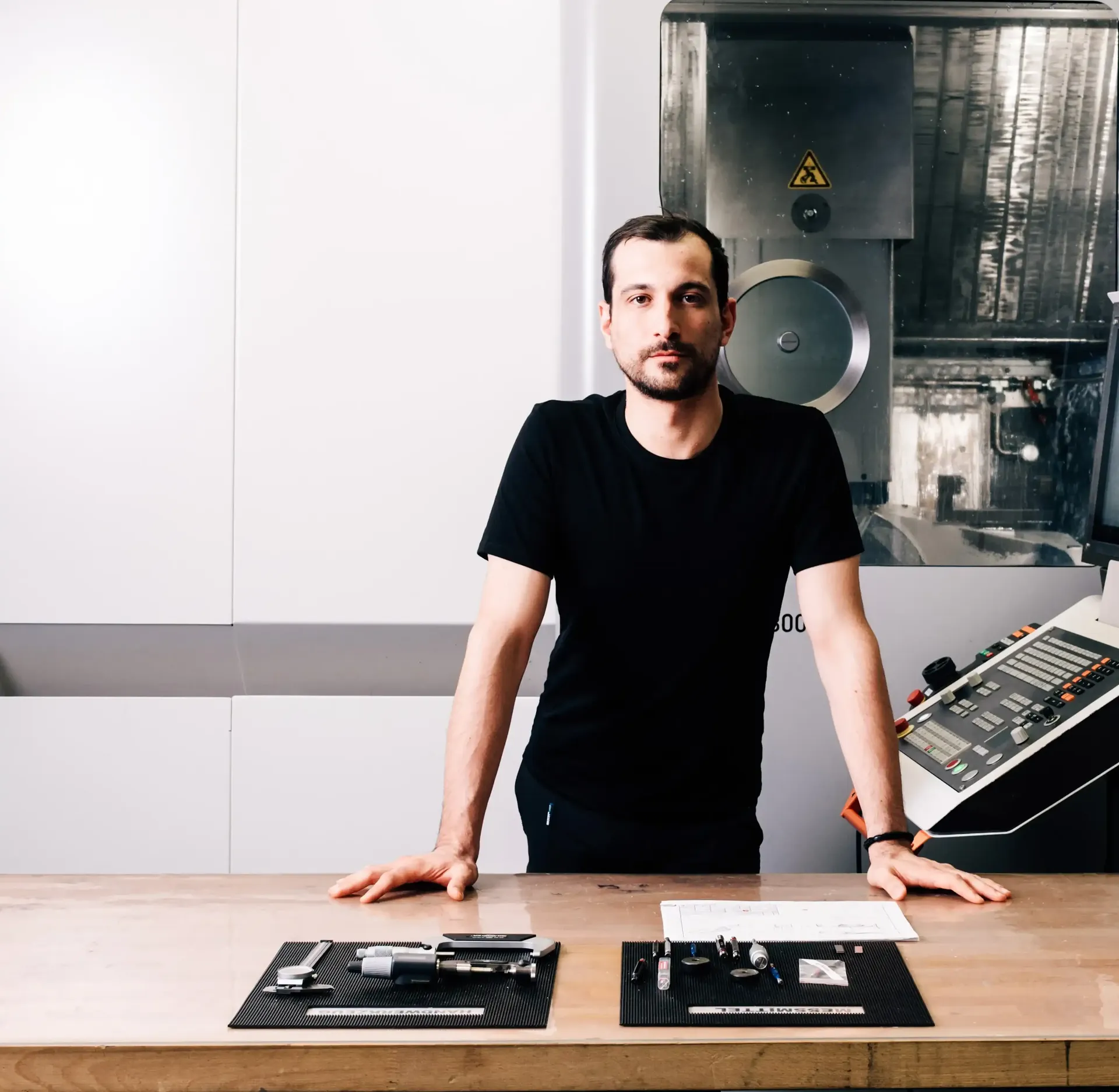 Close Up of CNC Meal Operator Giovanni working on his tool bench inside the lab