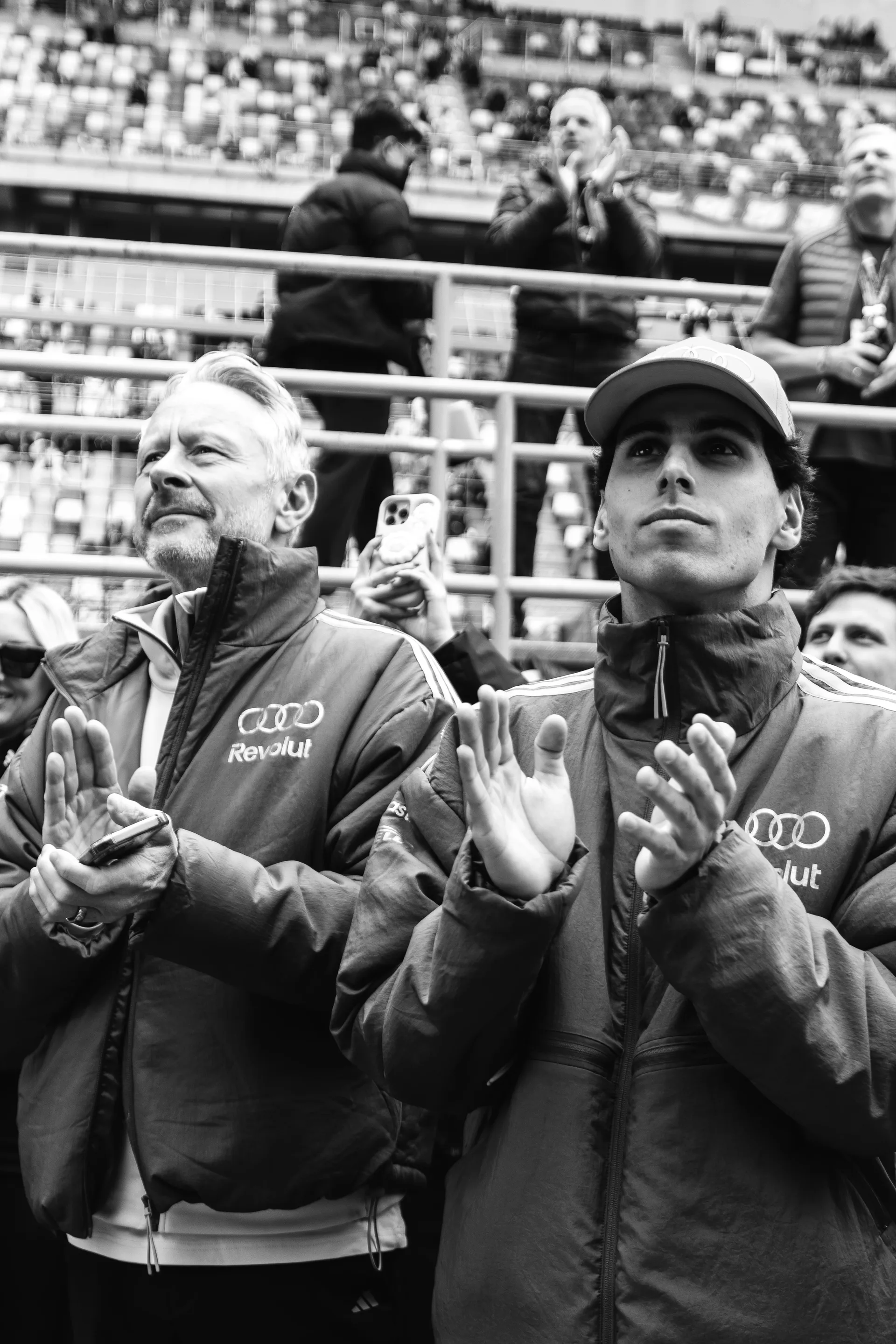 Jonathan Wheatley and Gabriel Bortoleto applaud from the grandstand during Emma Felbermayr’s podium ceremony in Shanghai.