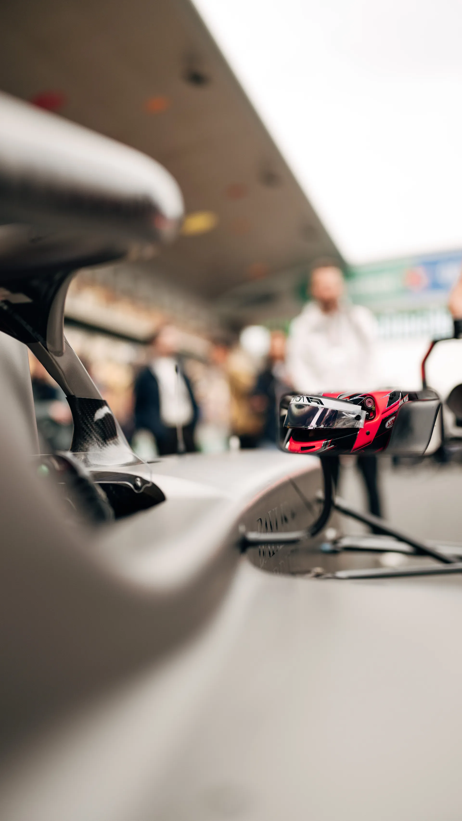 Close up of Emma Felbermayr’s helmet reflected in the side mirror of her F1 Academy car on the Shanghai grid.