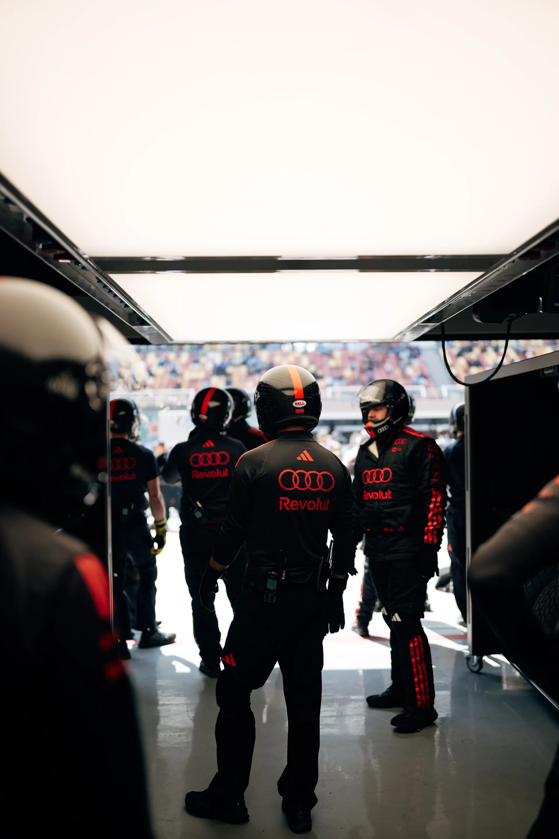 Audi Revolut F1® Team pit crew stand inside the garage entrance in Shanghai, ready for pit stop practice.