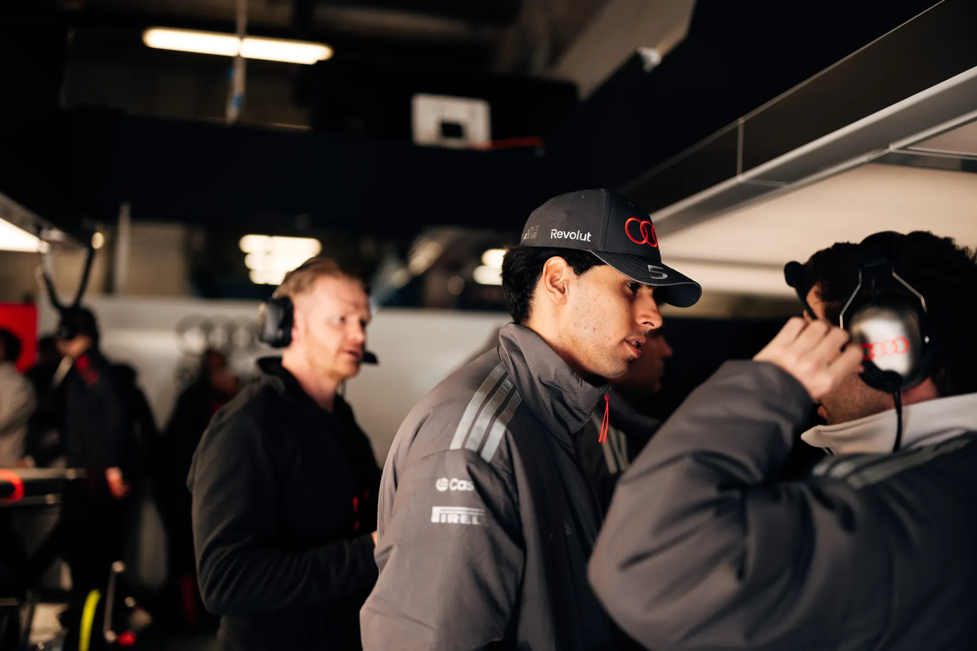 Gabriel Bortoleto speaks with an Audi Revolut F1® Team engineer wearing a headset inside the Shanghai garage.