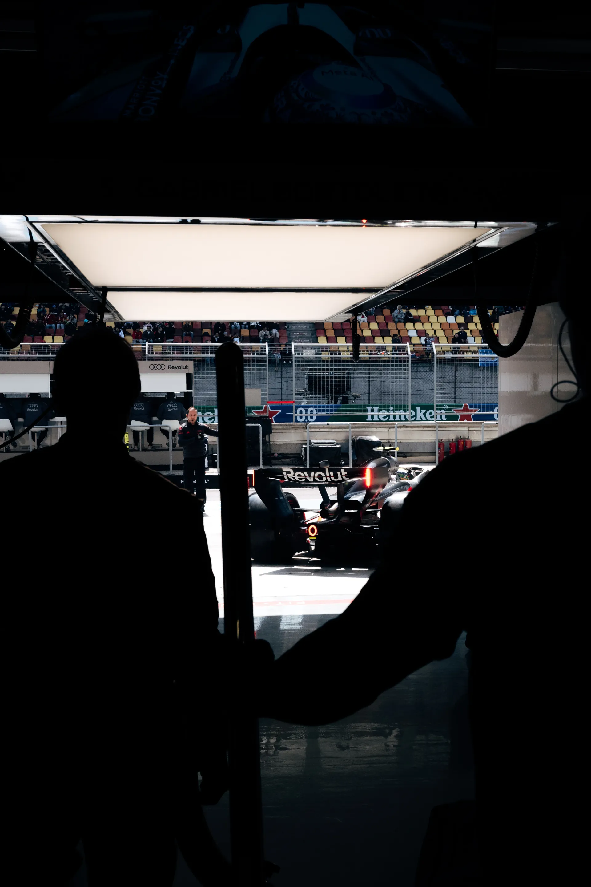 Silhouetted view from inside the Audi Revolut F1® Team garage as the race car sits in the Shanghai pit lane.
