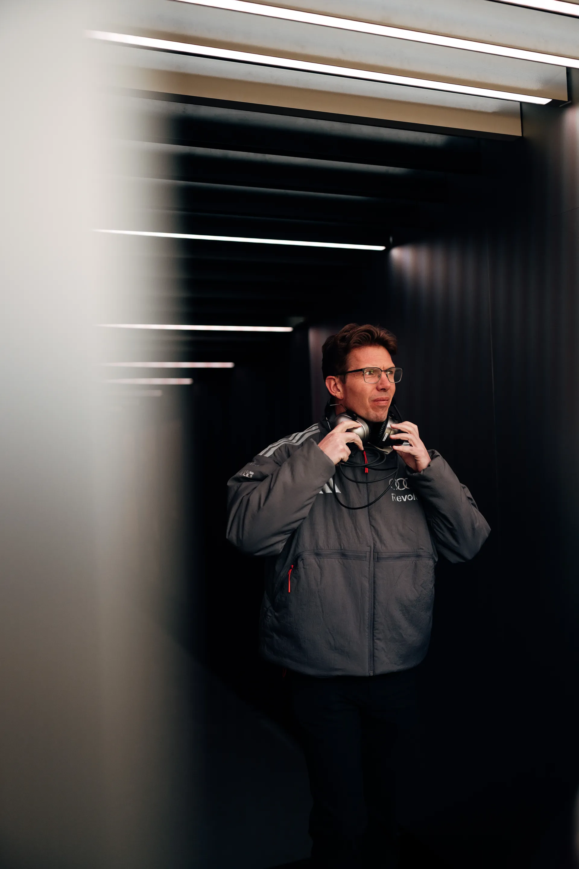 Audi Revolut F1® Team staff member stands in the garage tunnel in Shanghai with a headset around his neck.