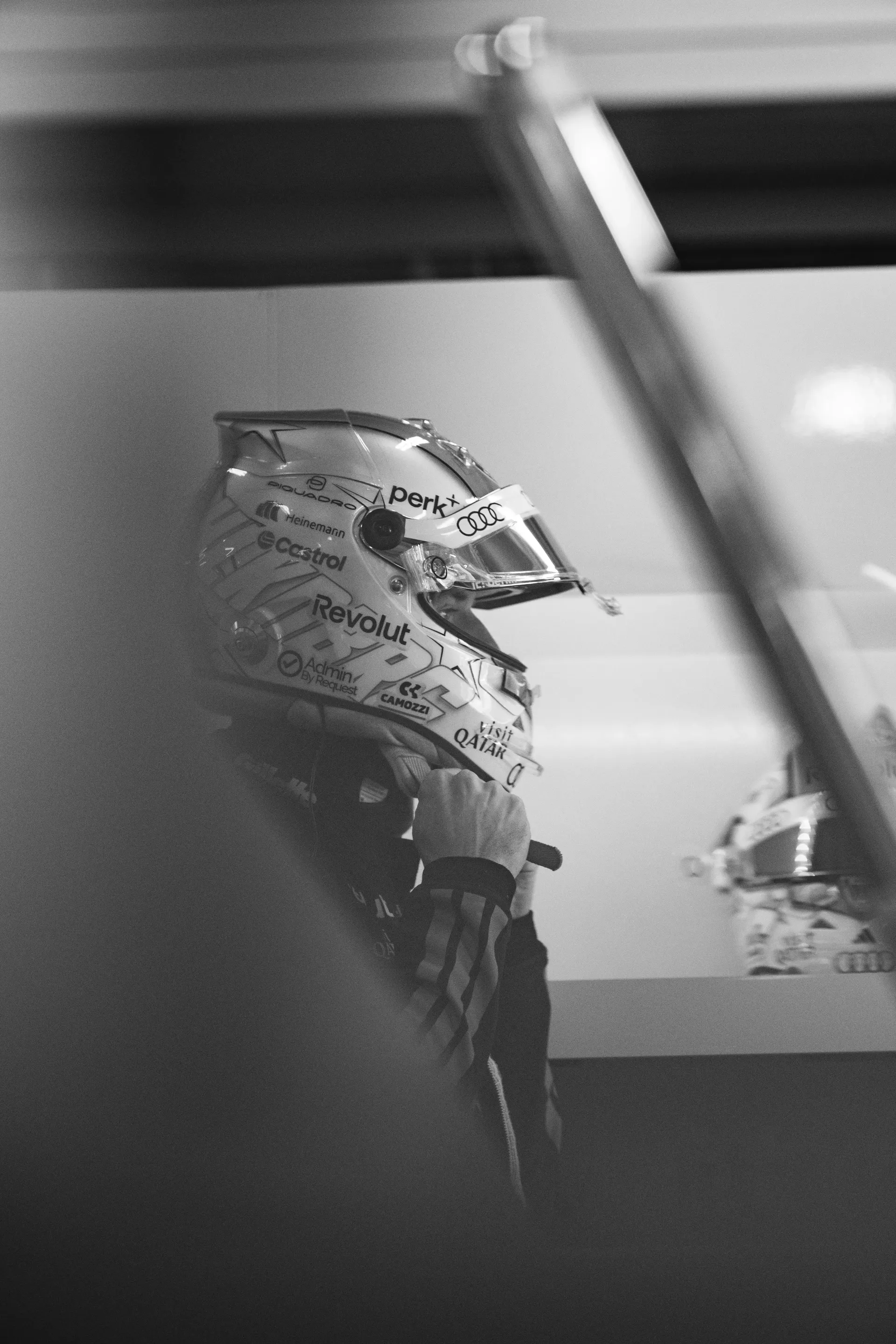 Black and white close-up of an Audi Revolut F1® Team driver Nico Hulkenberg wearing a helmet before entering the car.