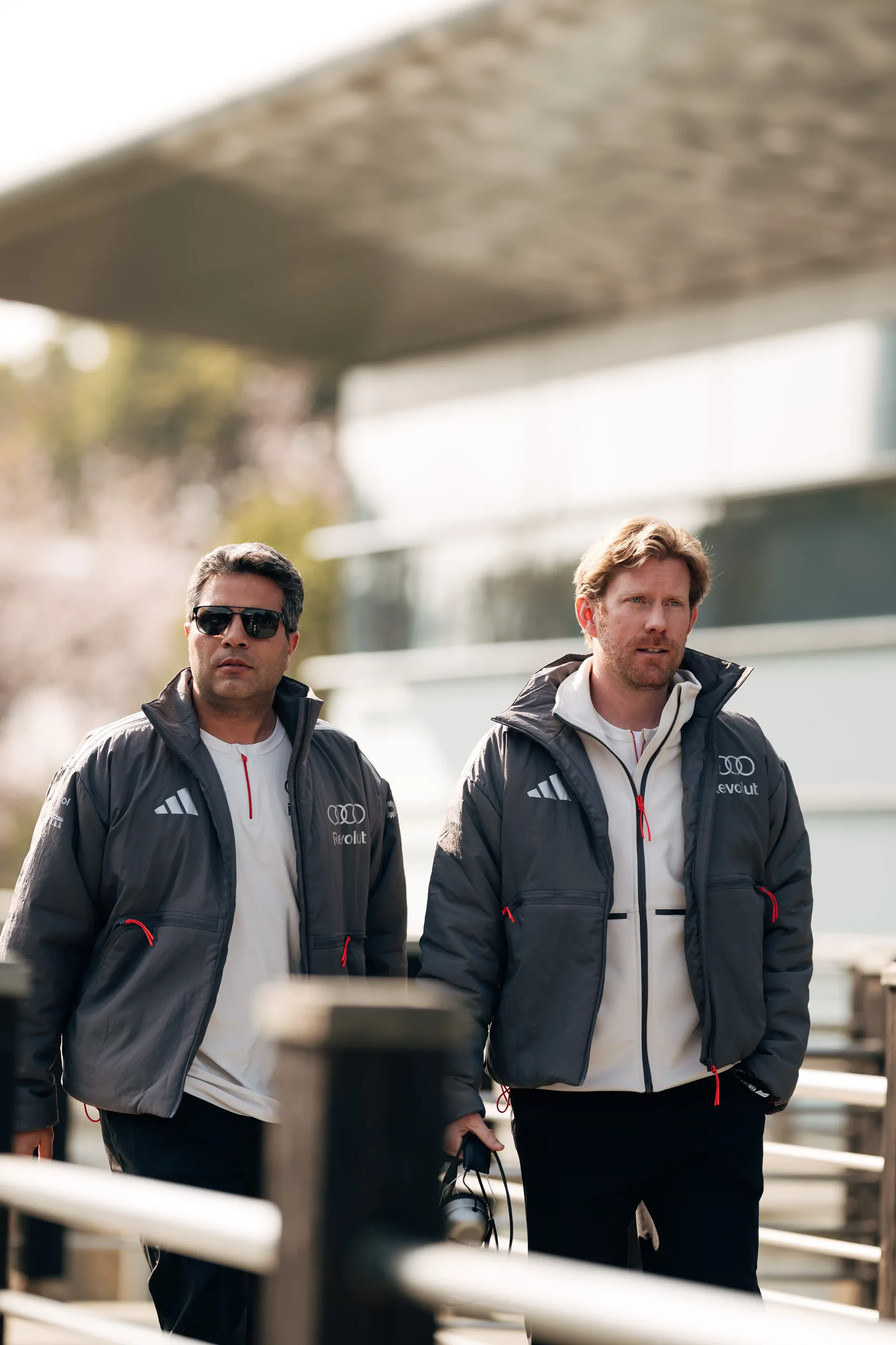 Two team members of the Audi Revolut F1® Team arriving in the paddock area ahead of the Formula 1 practice session in Shanghai.