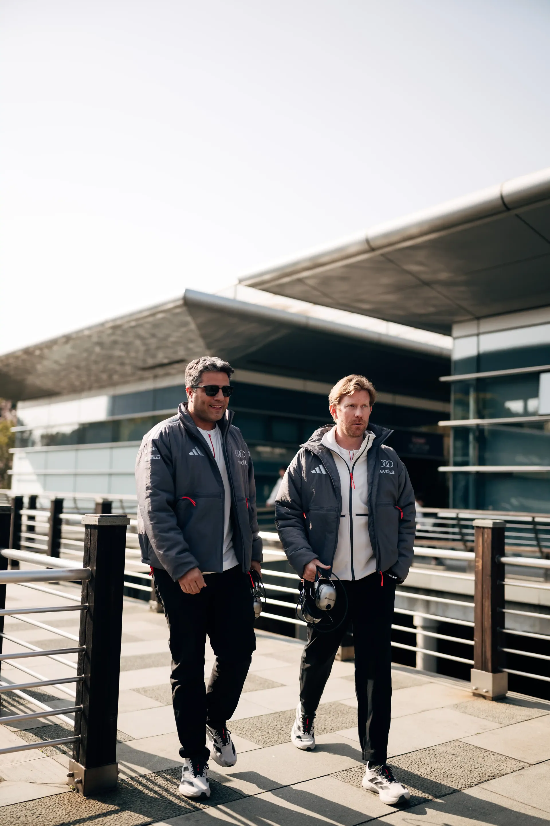 Audi Revolut F1® Team personnel walking along the paddock walkway at the Formula 1 Chinese Grand Prix weekend.