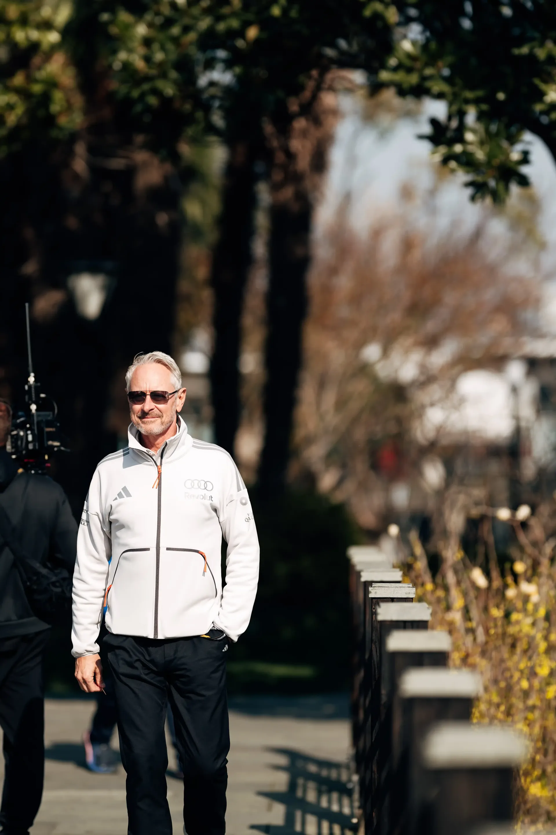 Senior Audi Revolut F1® Team staff member walking through the paddock during the F1 Chinese Grand Prix event.