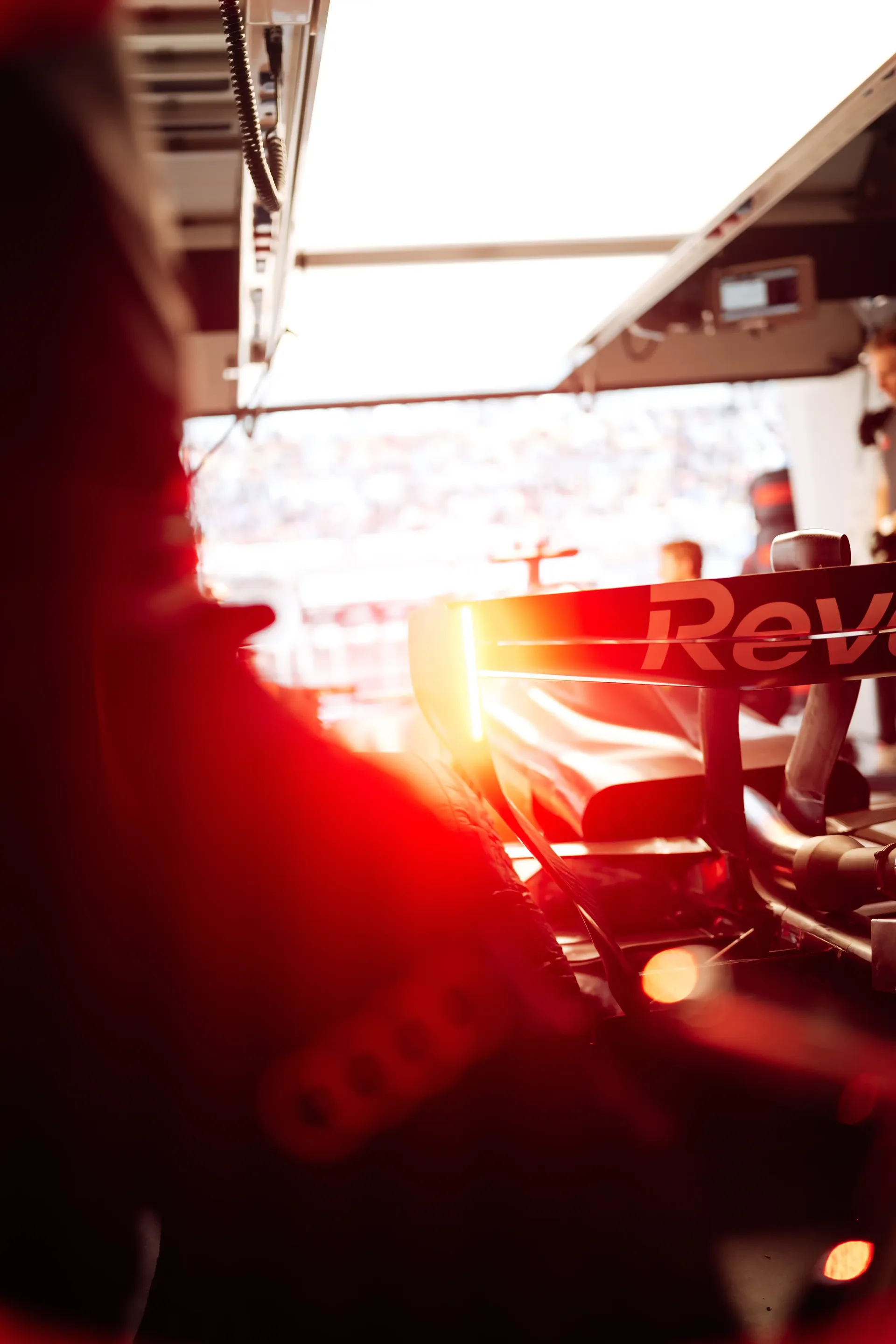 Rear view of the Audi Revolut F1® Team Formula 1 car inside the garage with glowing rear light during practice.
