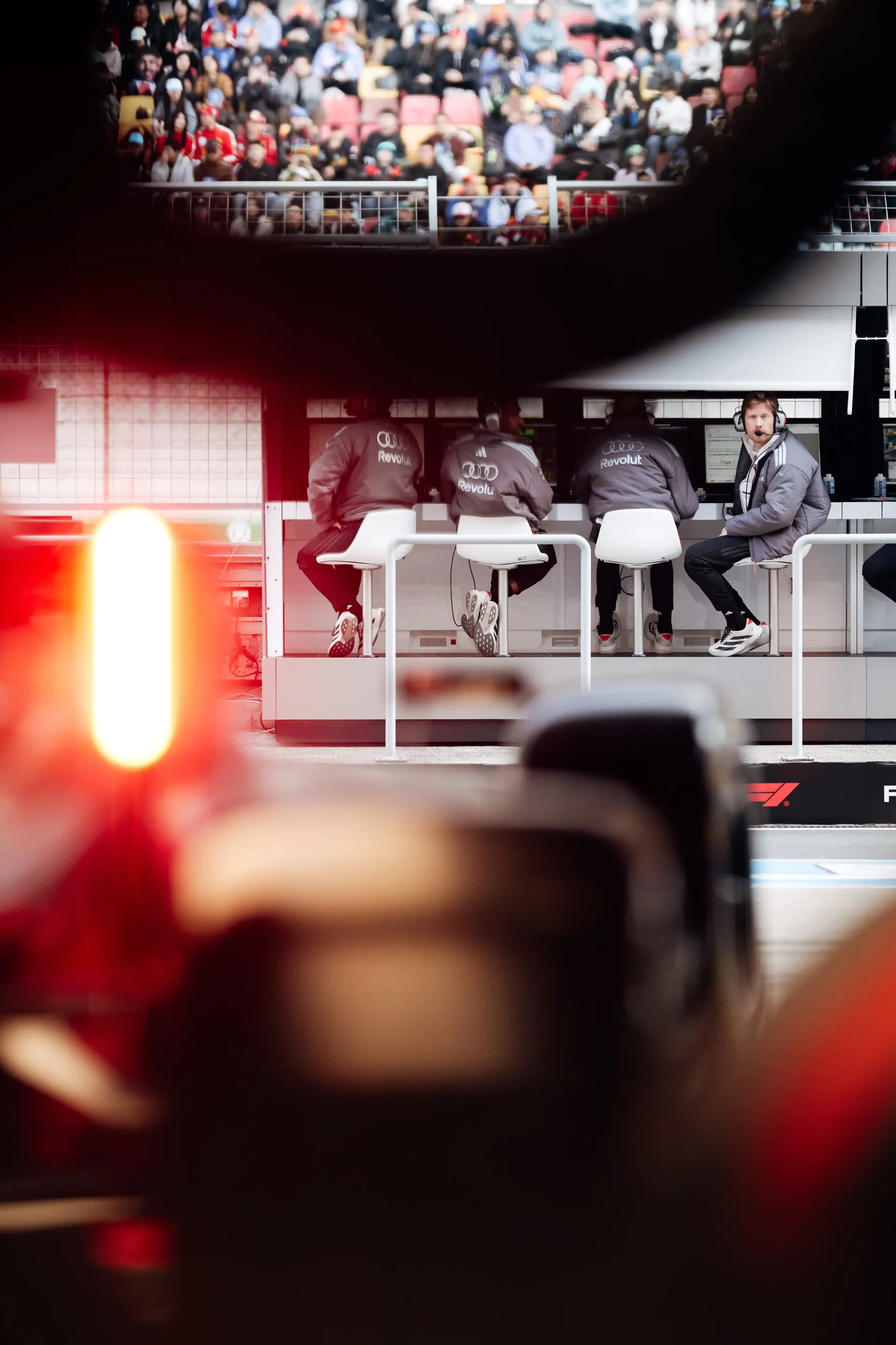 Rear light of the Audi Revolut F1® Team Formula 1 car illuminated in the garage during practice.