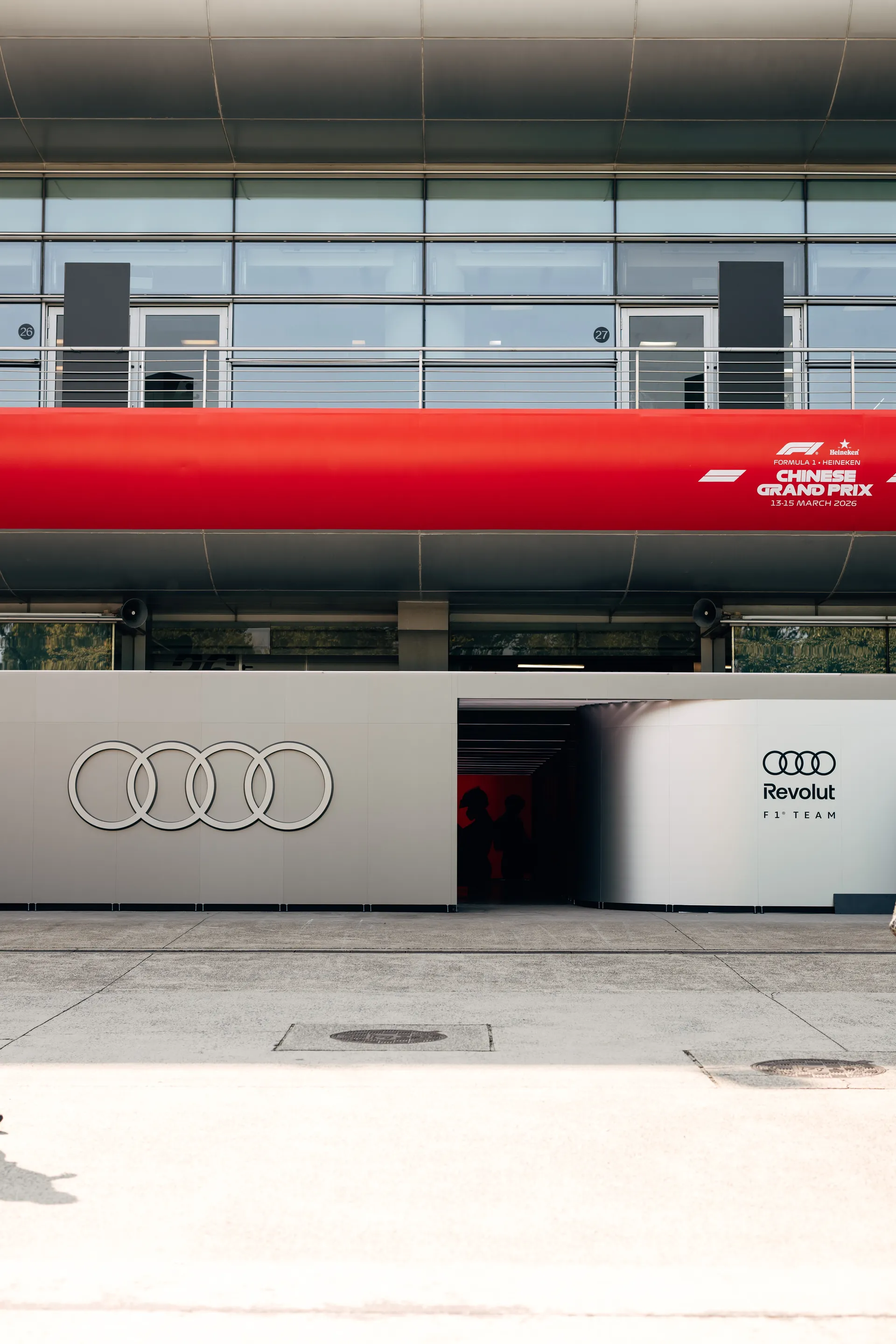 Audi Revolut F1® Team garage exterior at the Chinese Grand Prix, with team branding beneath official Shanghai race signage.