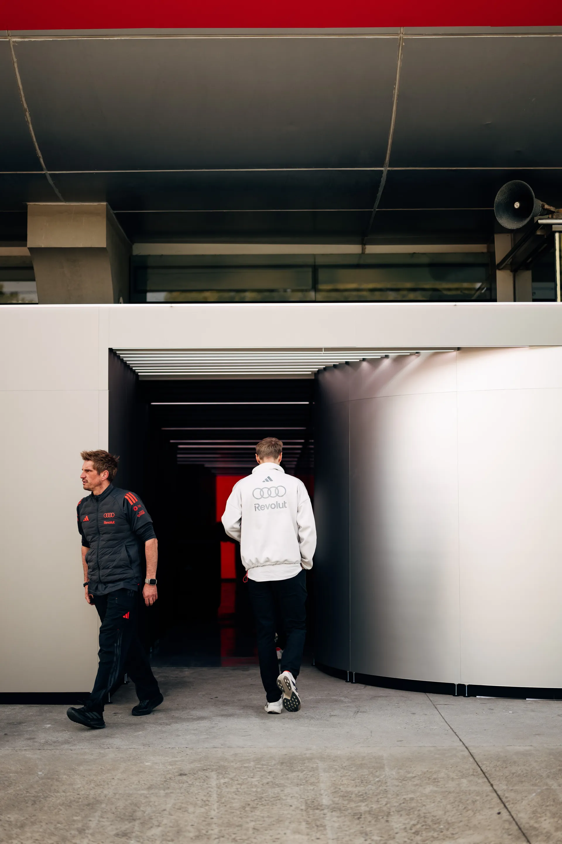 Audi Revolut F1® Team personnel enter the team garage in Shanghai during race weekend preparations.