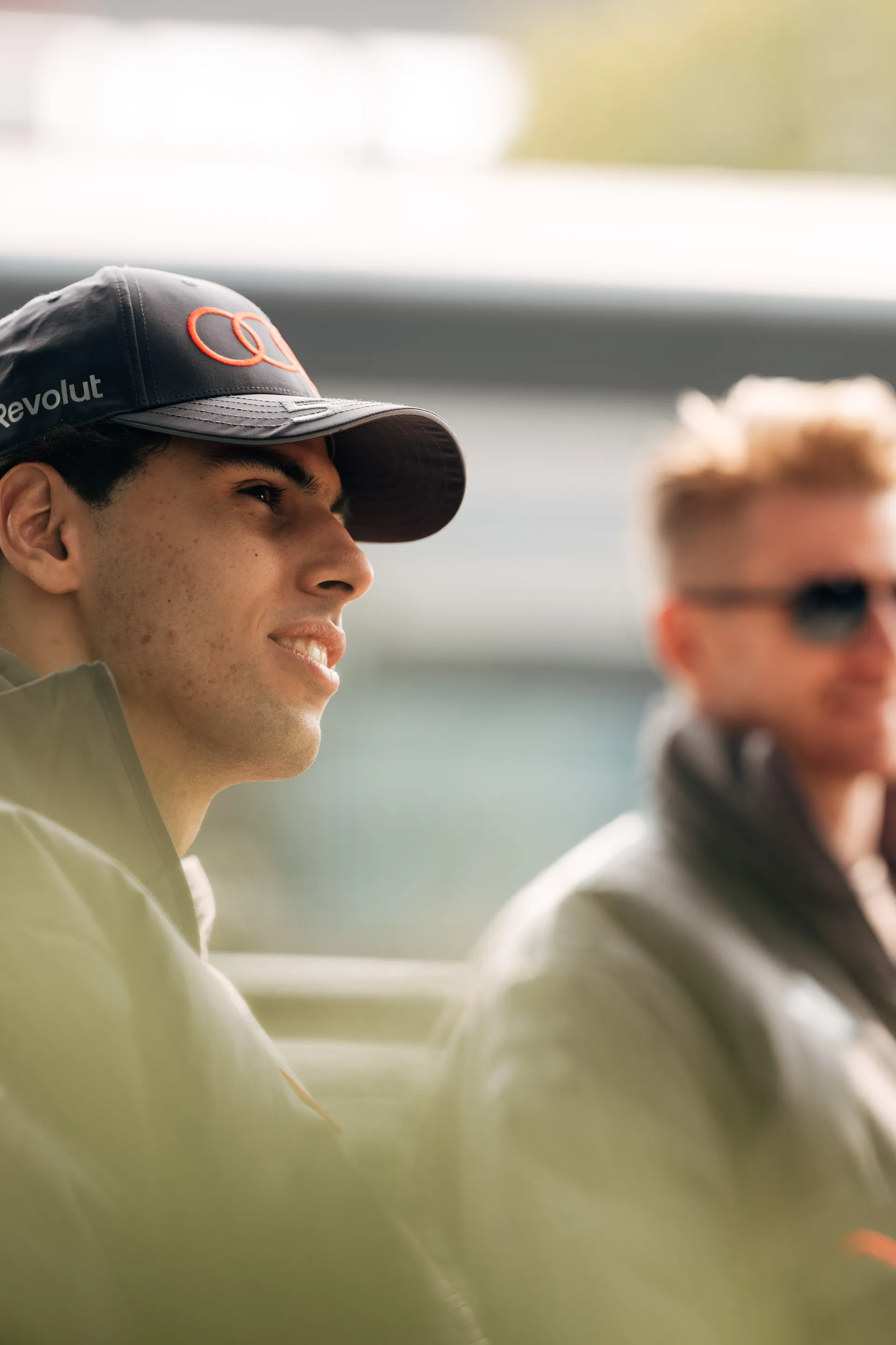 Two Audi Revolut F1® Team drivers Gabriel Bortoleto and Nico Hulkenberg sit together in the paddock in Shanghai during the Chinese Grand Prix weekend.