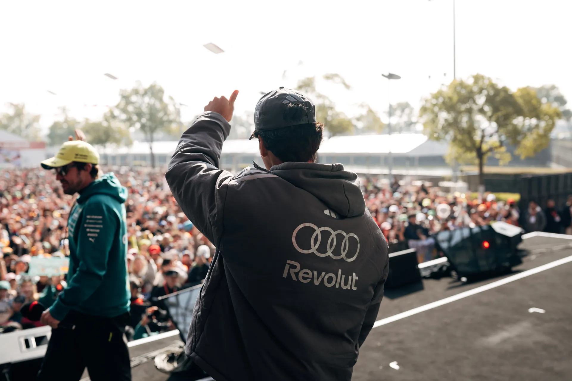 Gabriel Bortoleto waves to a packed crowd from the Audi Revolut F1® Team stage in Shanghai.