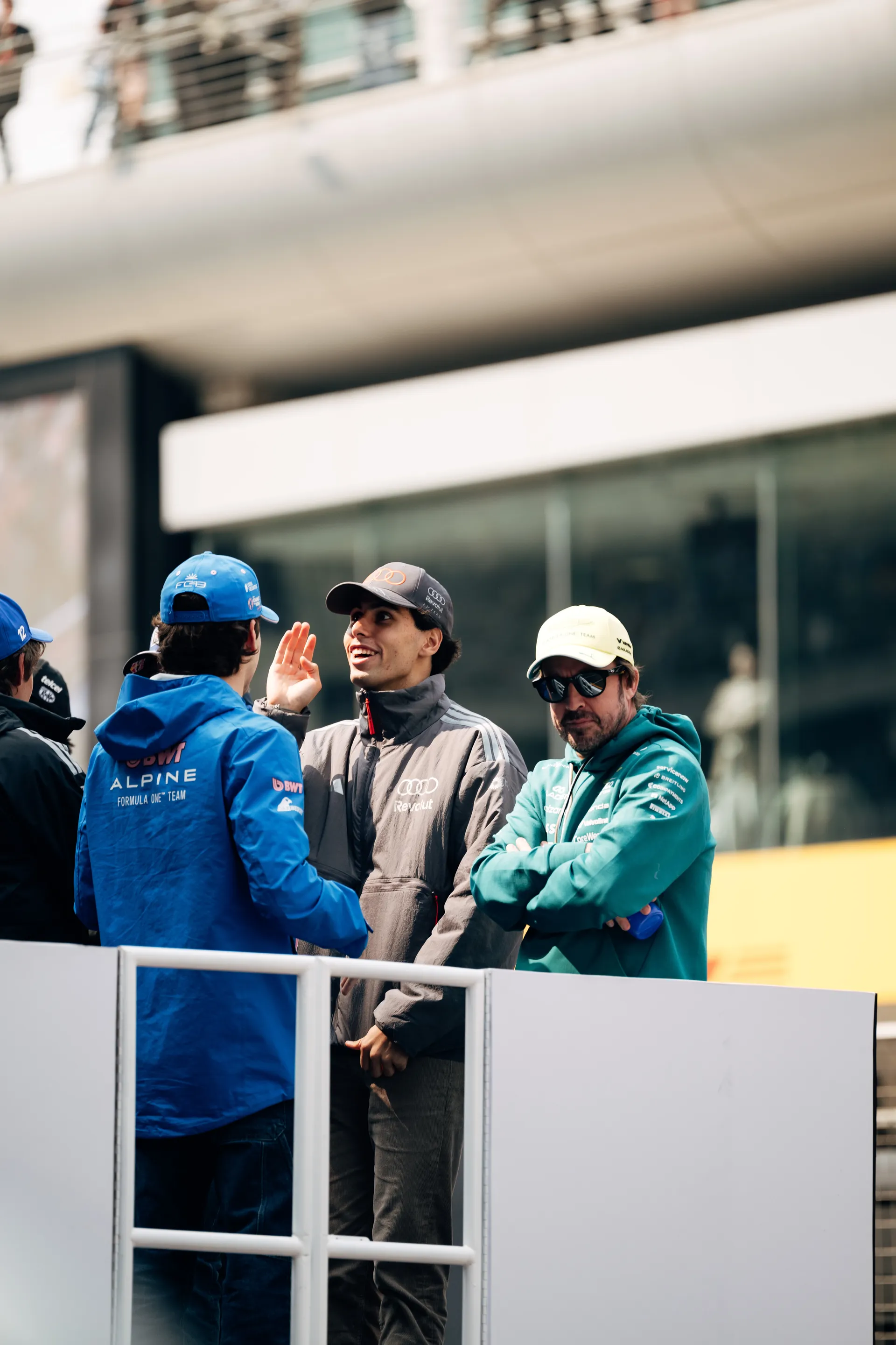 Gabriel Bortoleto chats with other drivers in the paddock during race day arrival at the Chinese Grand Prix.